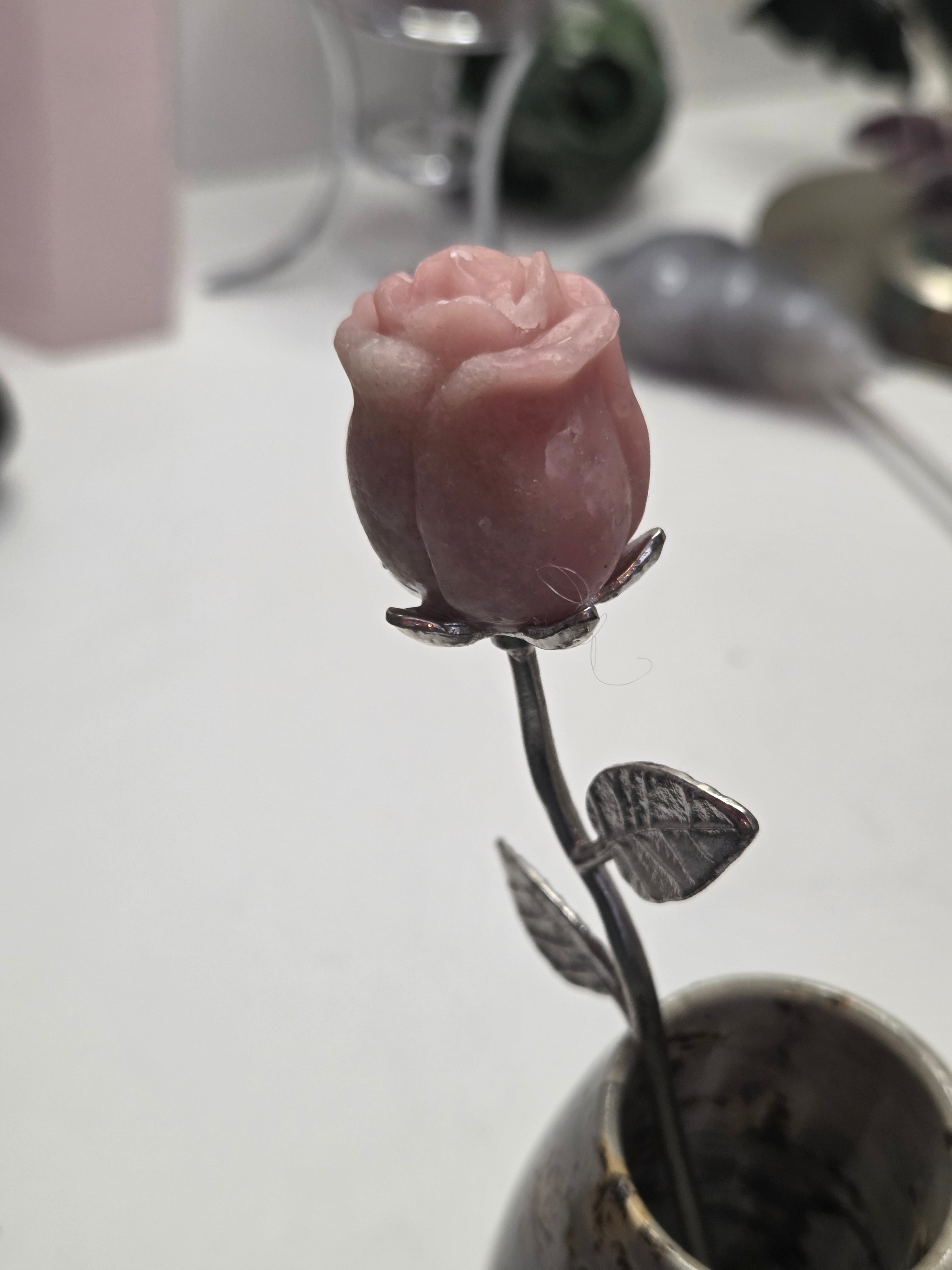 Pink opal crystal rose carving on a stem