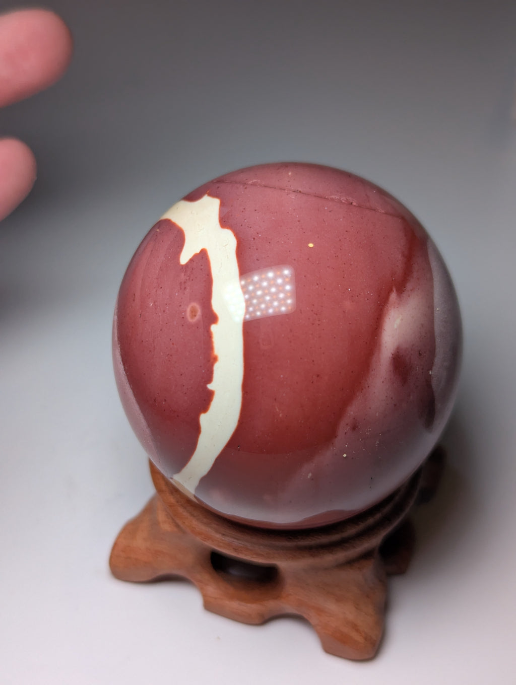 Mookite crystal sphere with stand