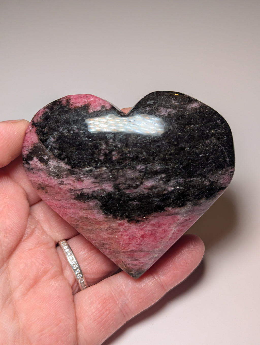 Large Rhodonite crystal heart carving with stand