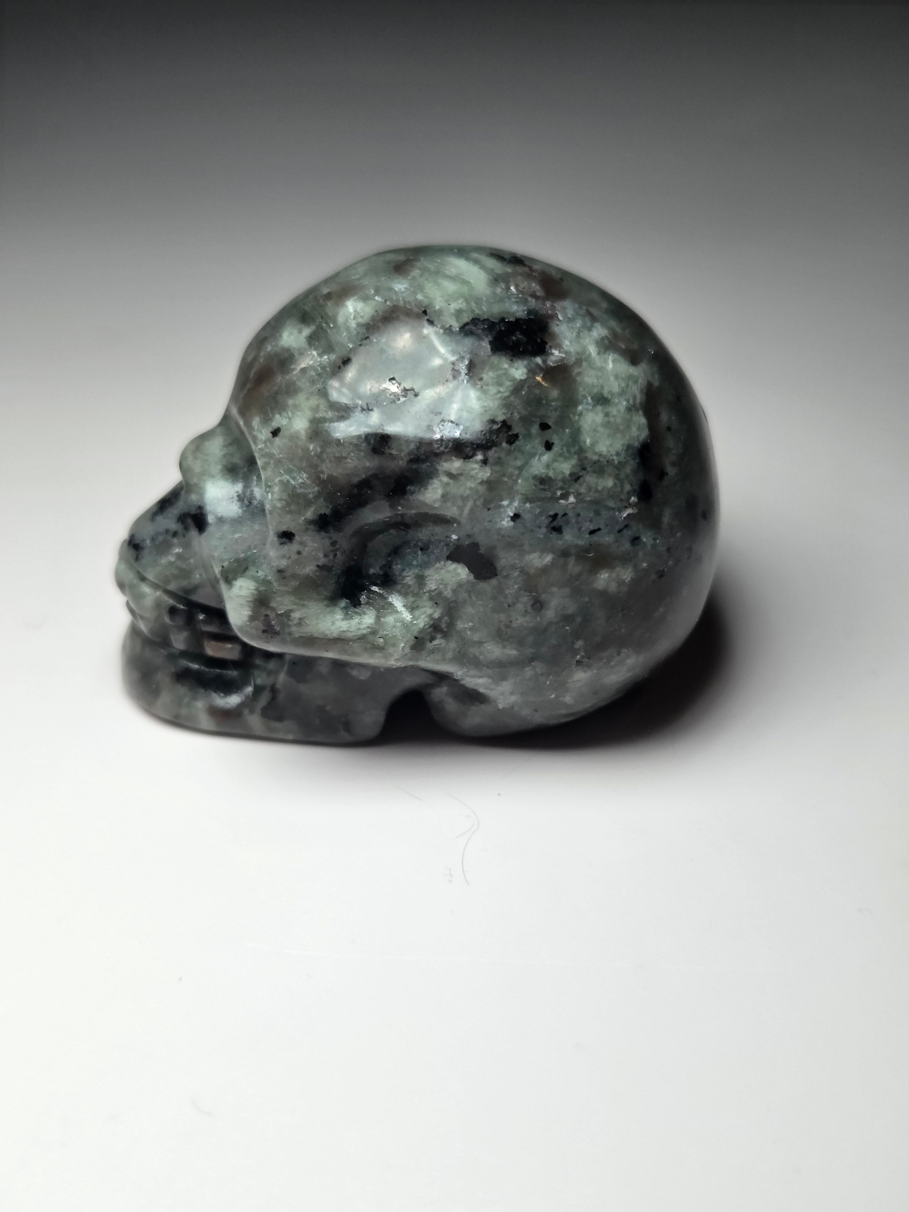 Yooperlite crystal skull carving with orange uv