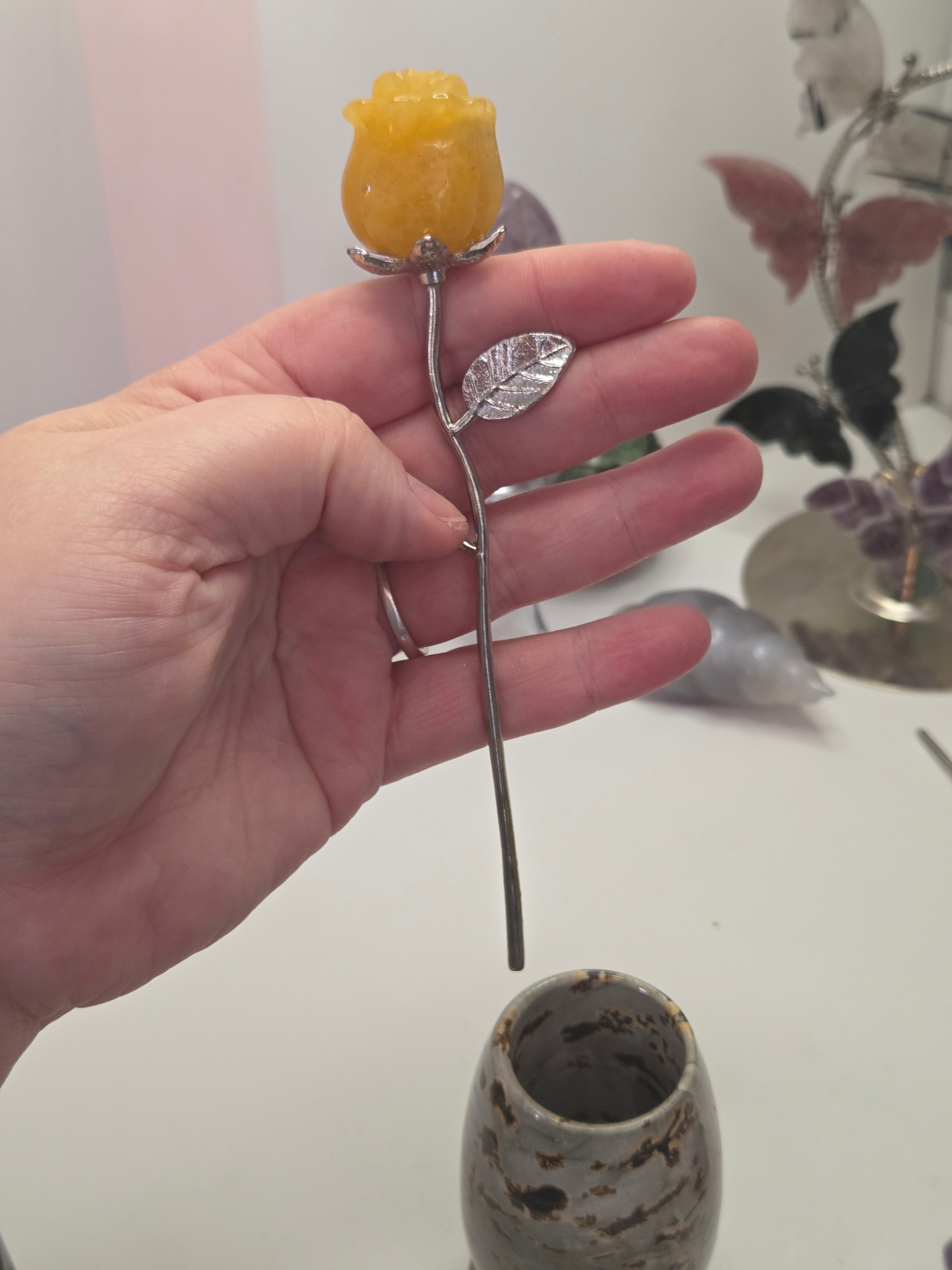 Golden healer crystal rose carving on a stem