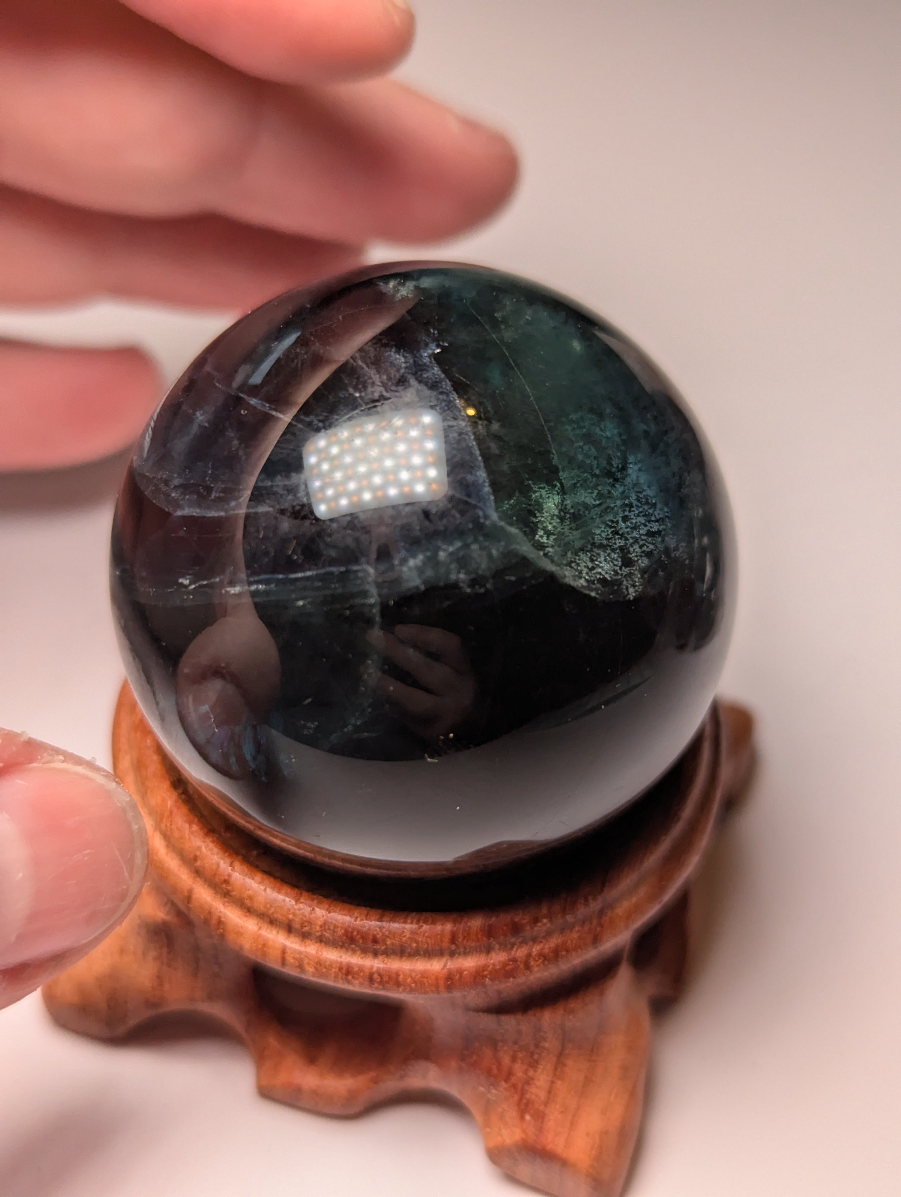 Black flourite crystal sphere with red UV with stand