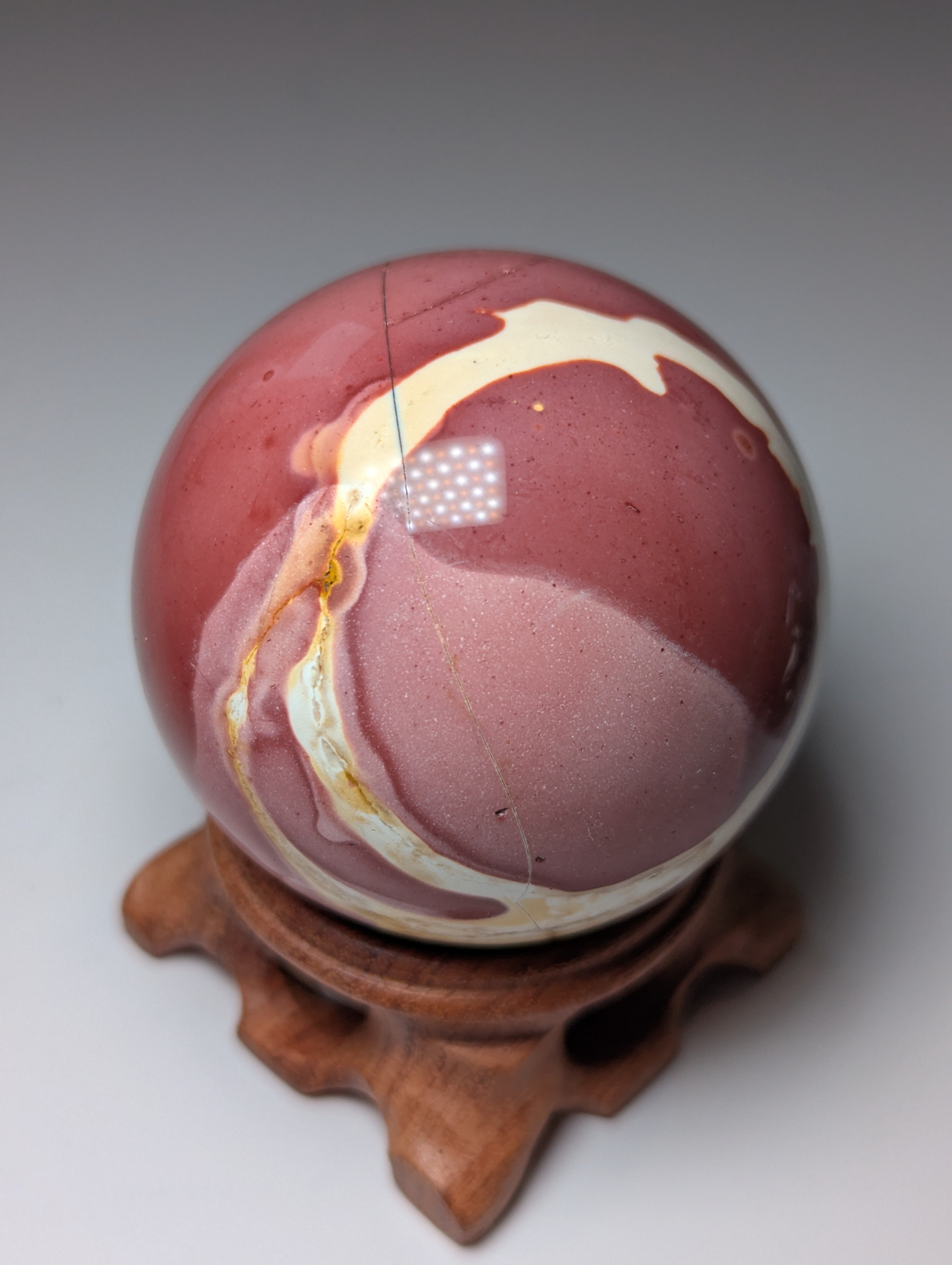 Mookite crystal sphere with stand