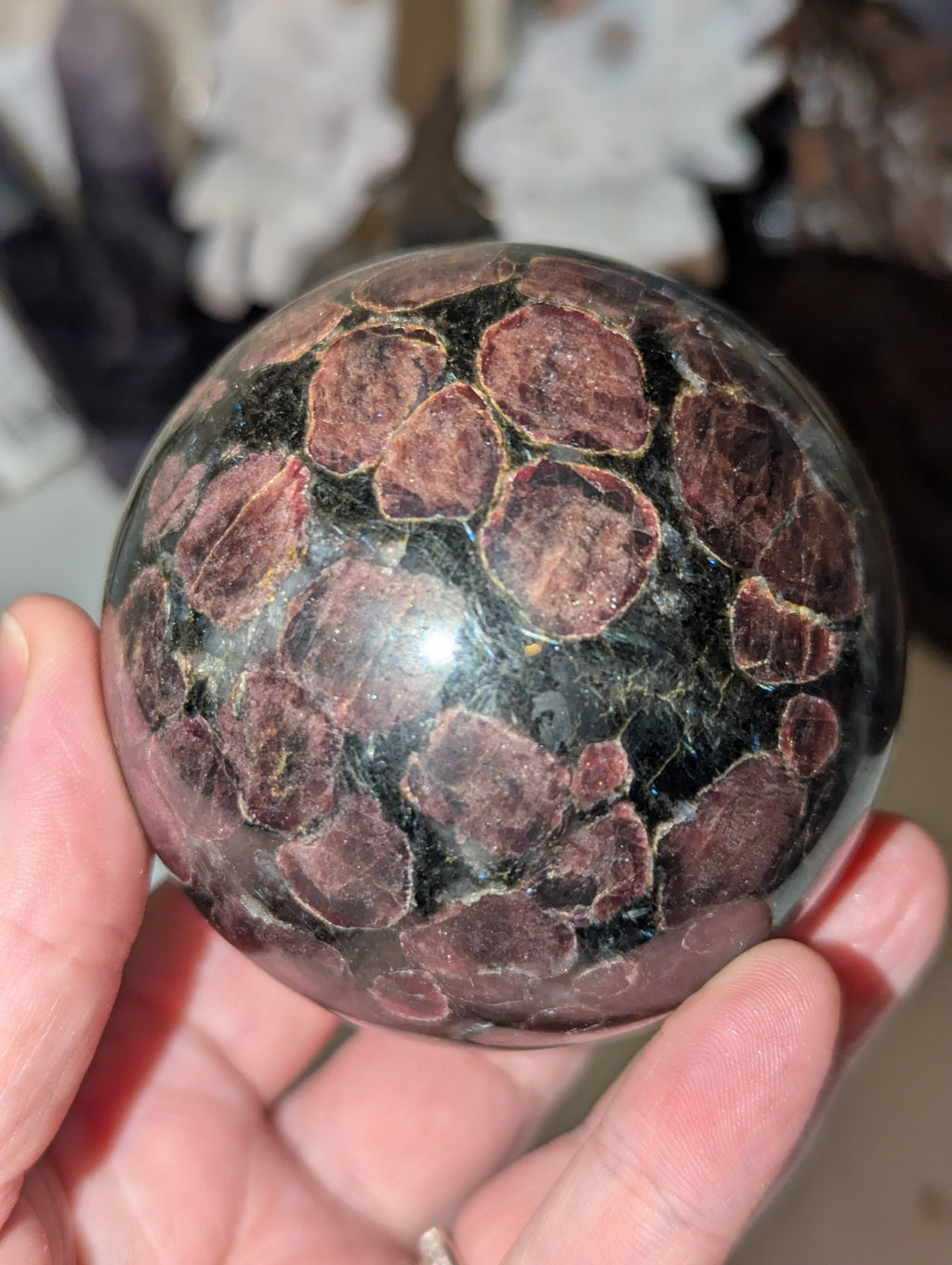 Astrophylite crystal sphere with garnet