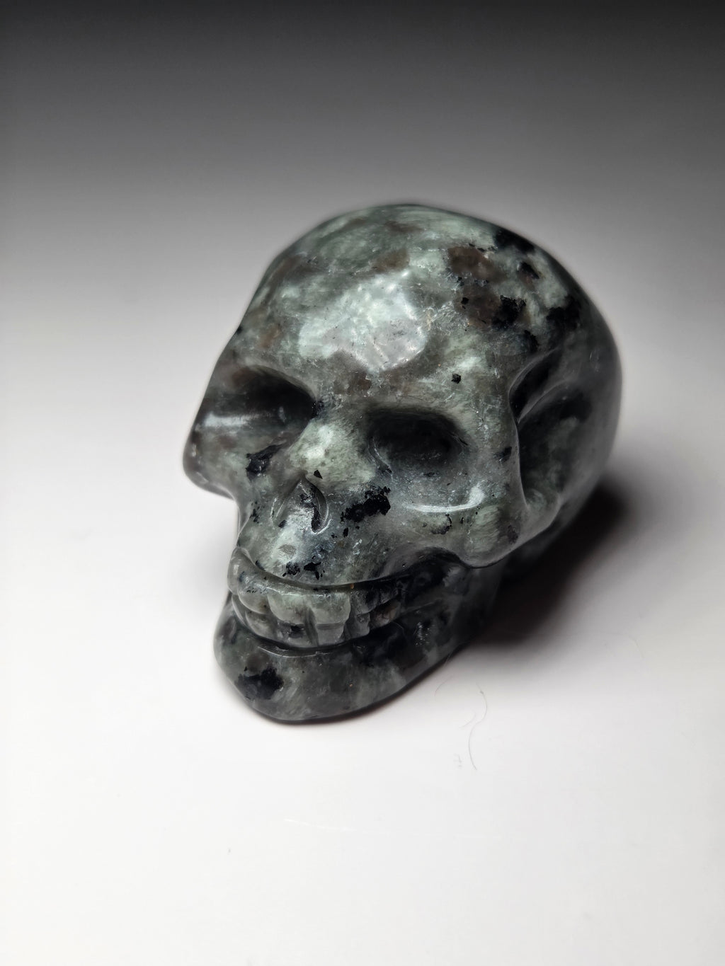 Yooperlite crystal skull carving with orange uv