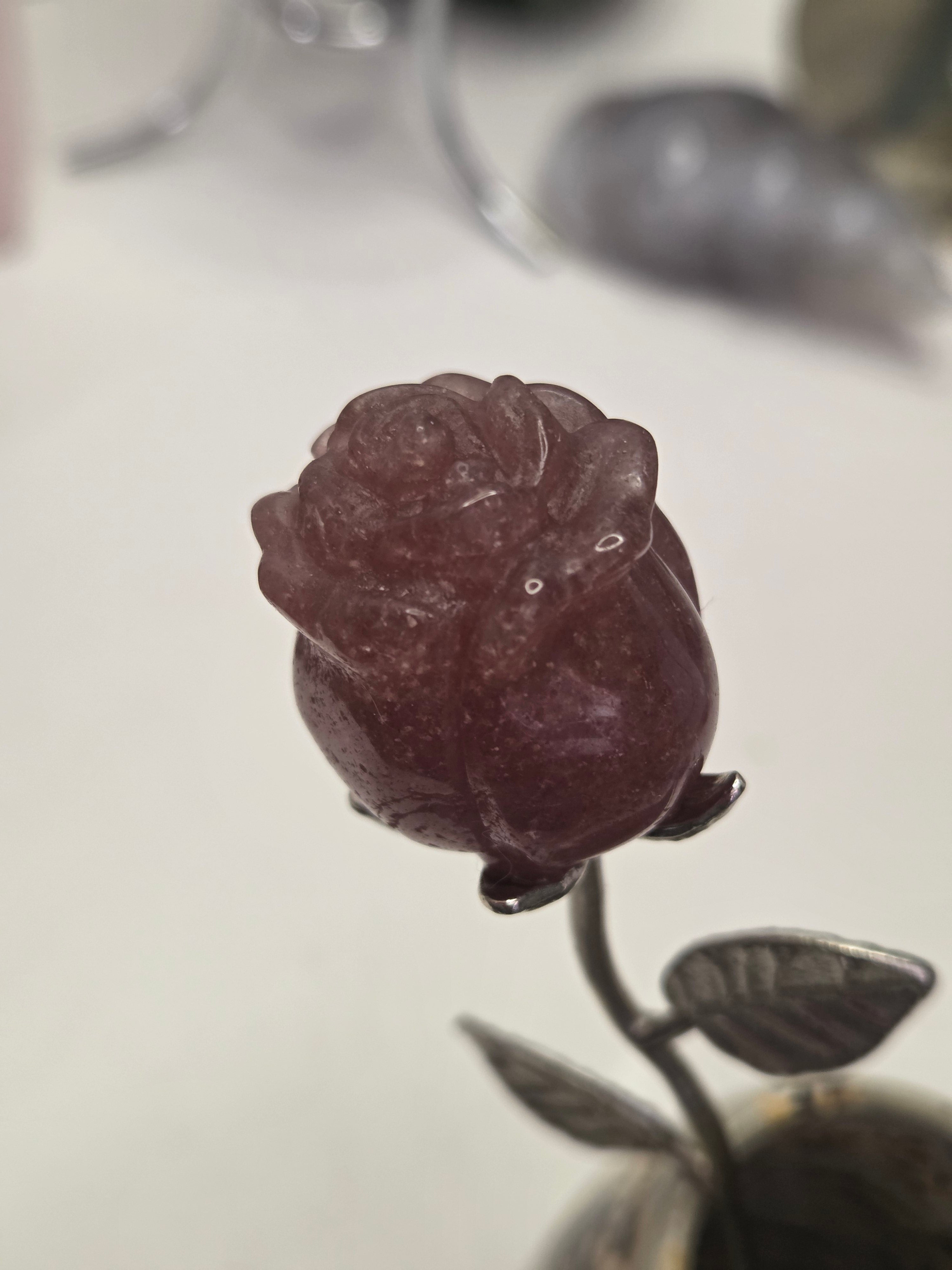 Strawberry quartz crystal rose carving on a stem