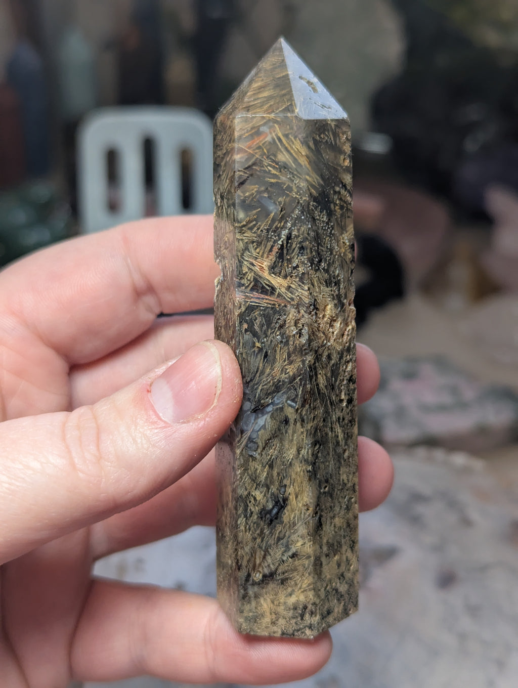 Golden rutile in black agate tower