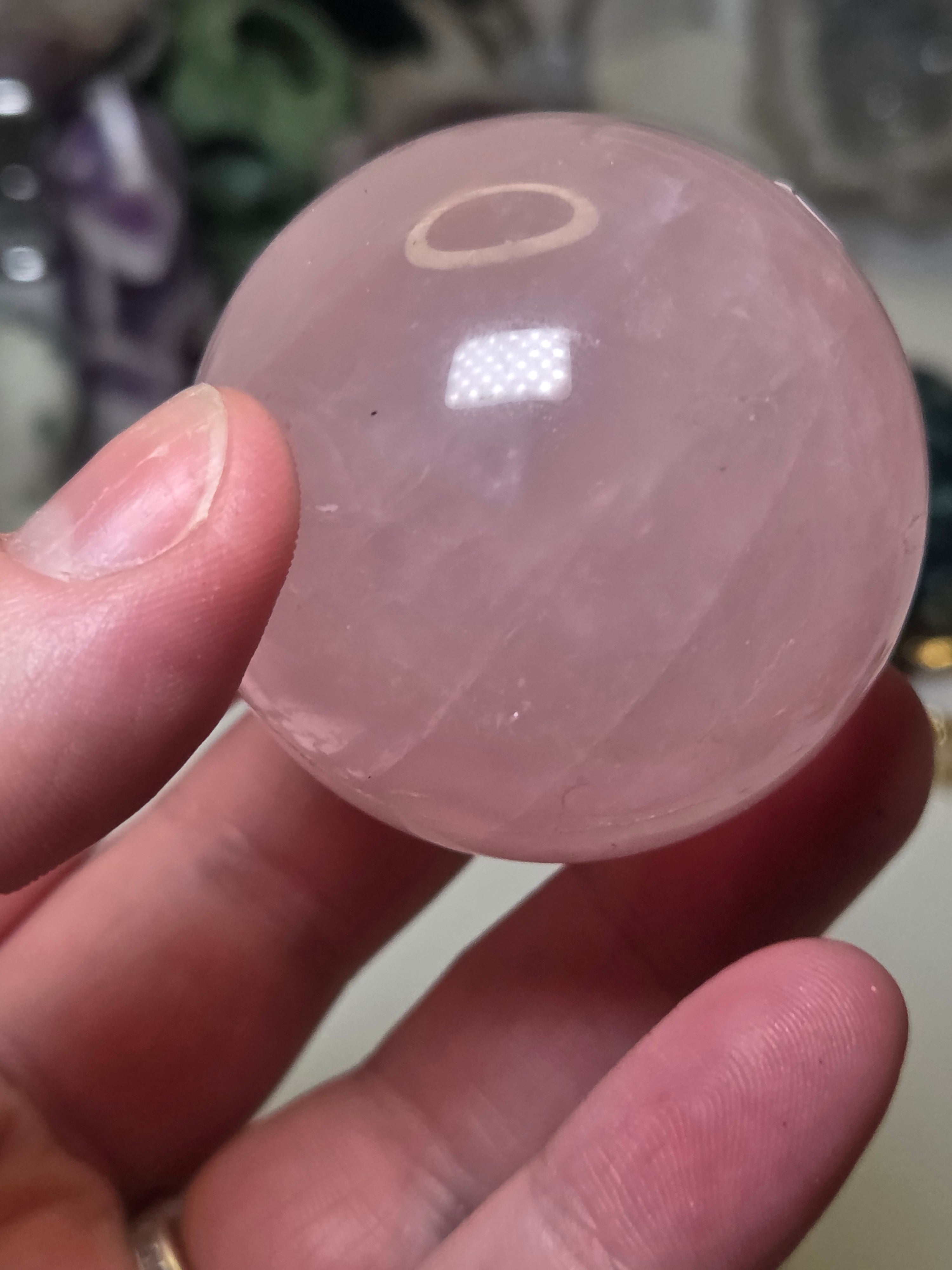 Rose quartz crystal sphere with  crack line and star flash