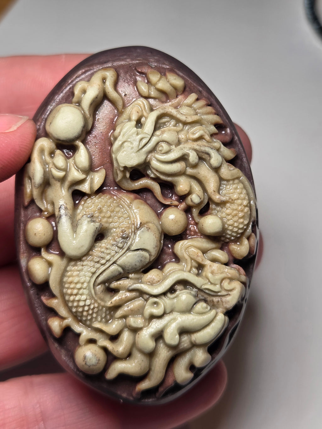 Handmade carved dragon palm stone in purple jade from Province