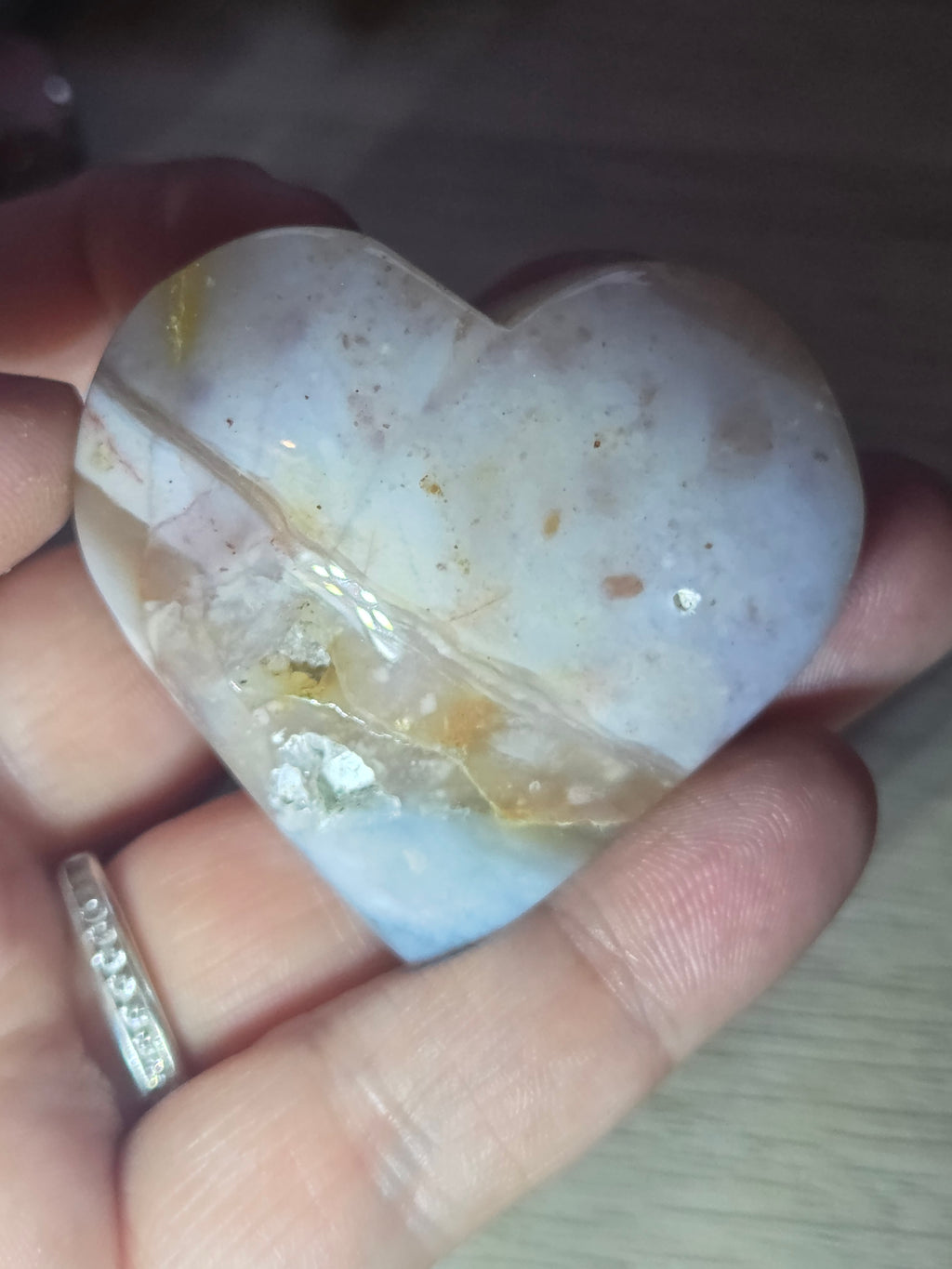 Pink petrified wood heart carving with UV