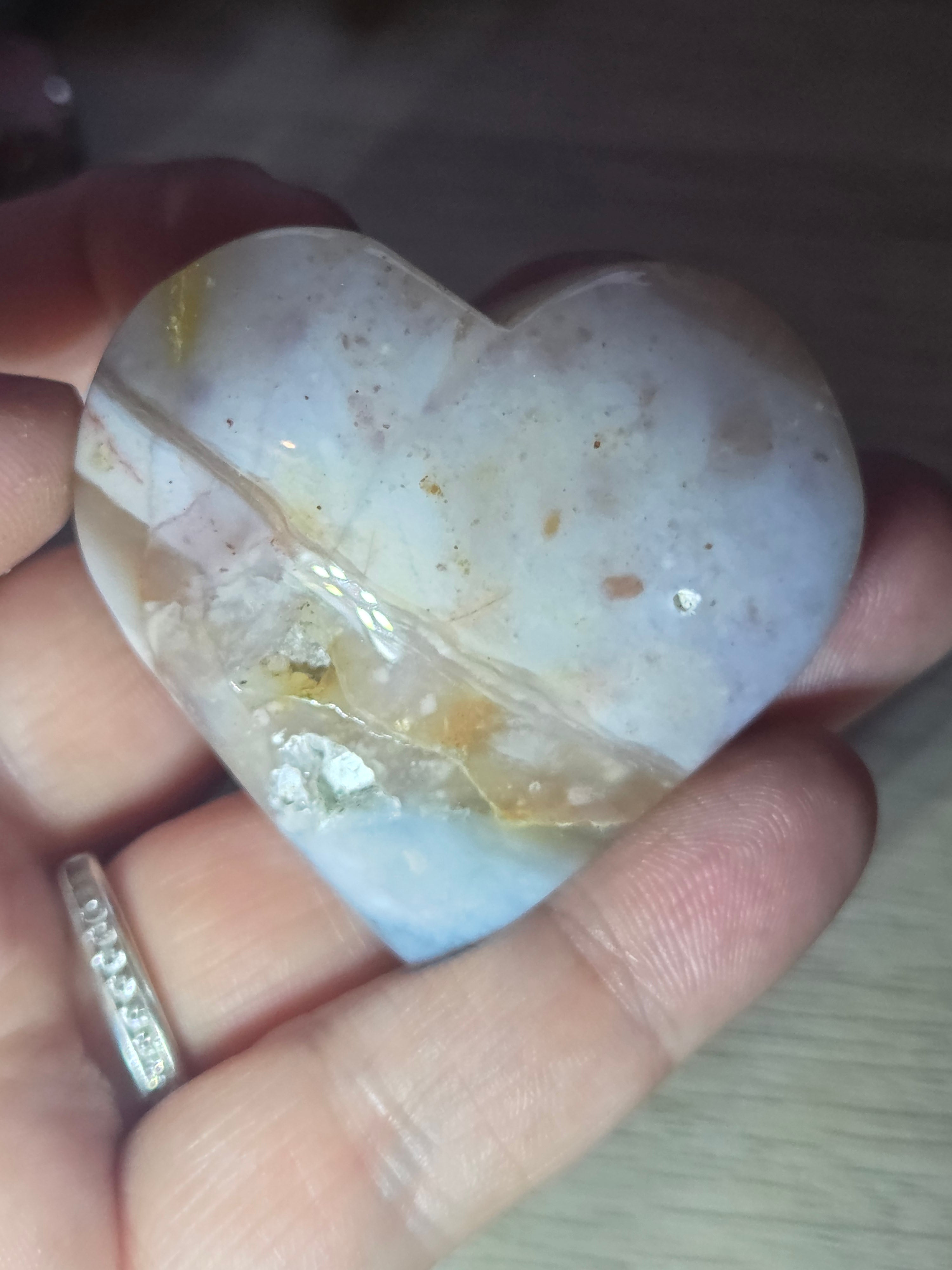 Pink petrified wood heart carving with UV