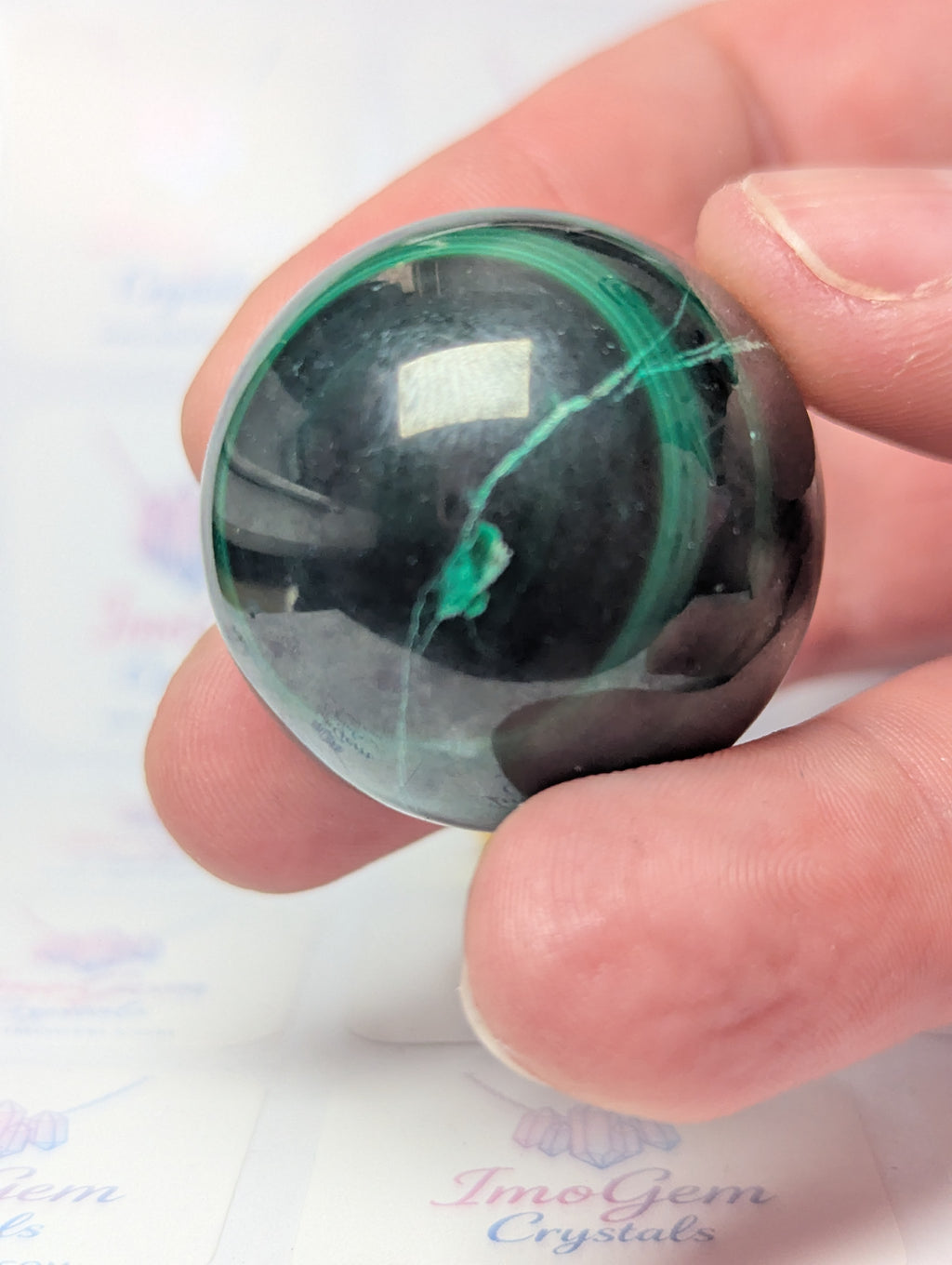 Malicite crystal sphere with imperfections