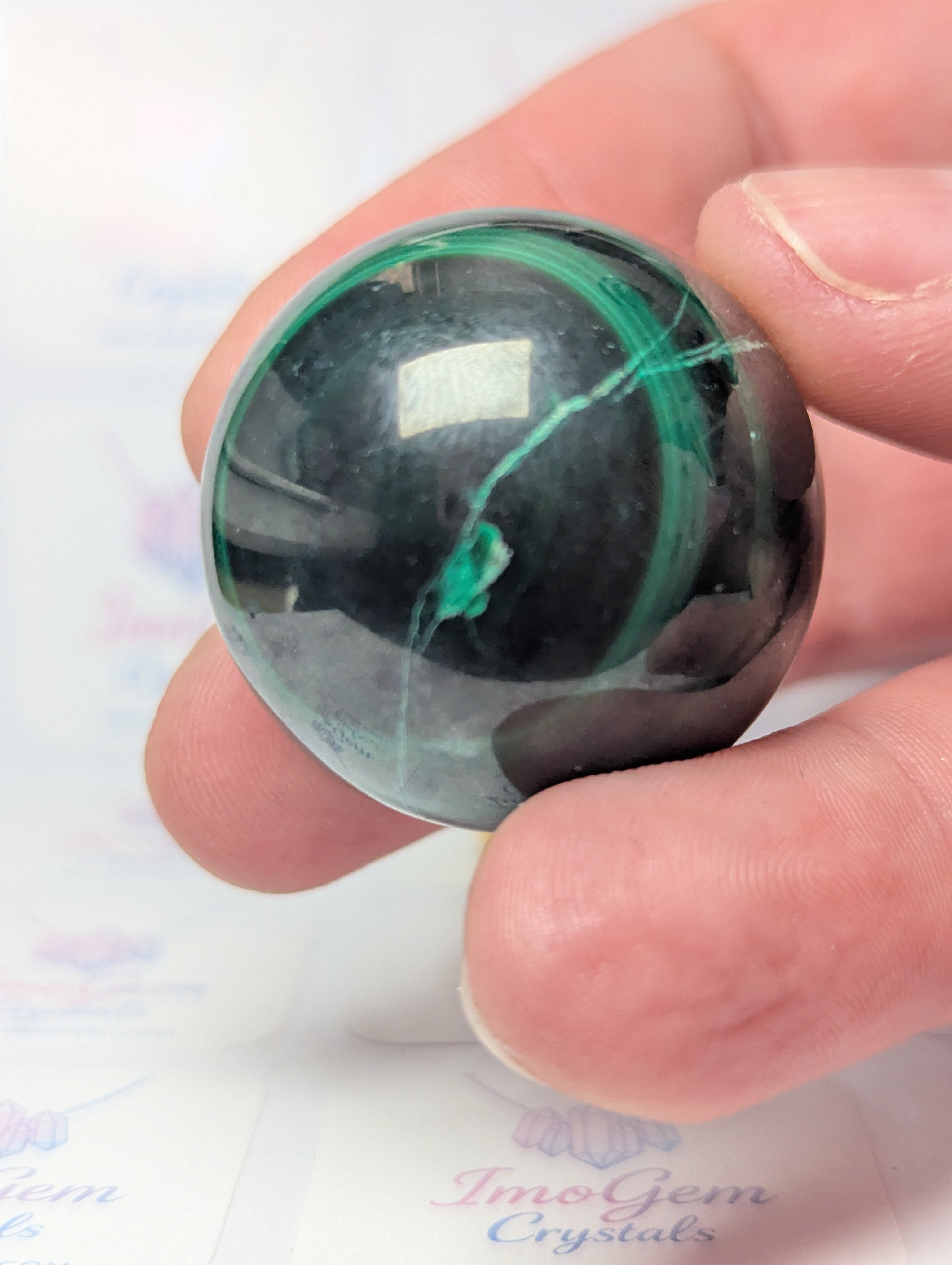 Malicite crystal sphere with imperfections