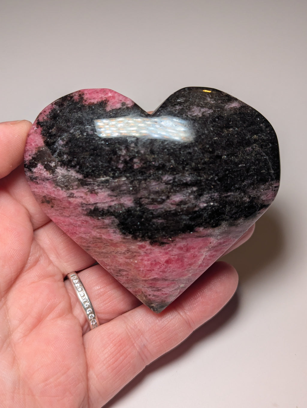 Large Rhodonite crystal heart carving with stand