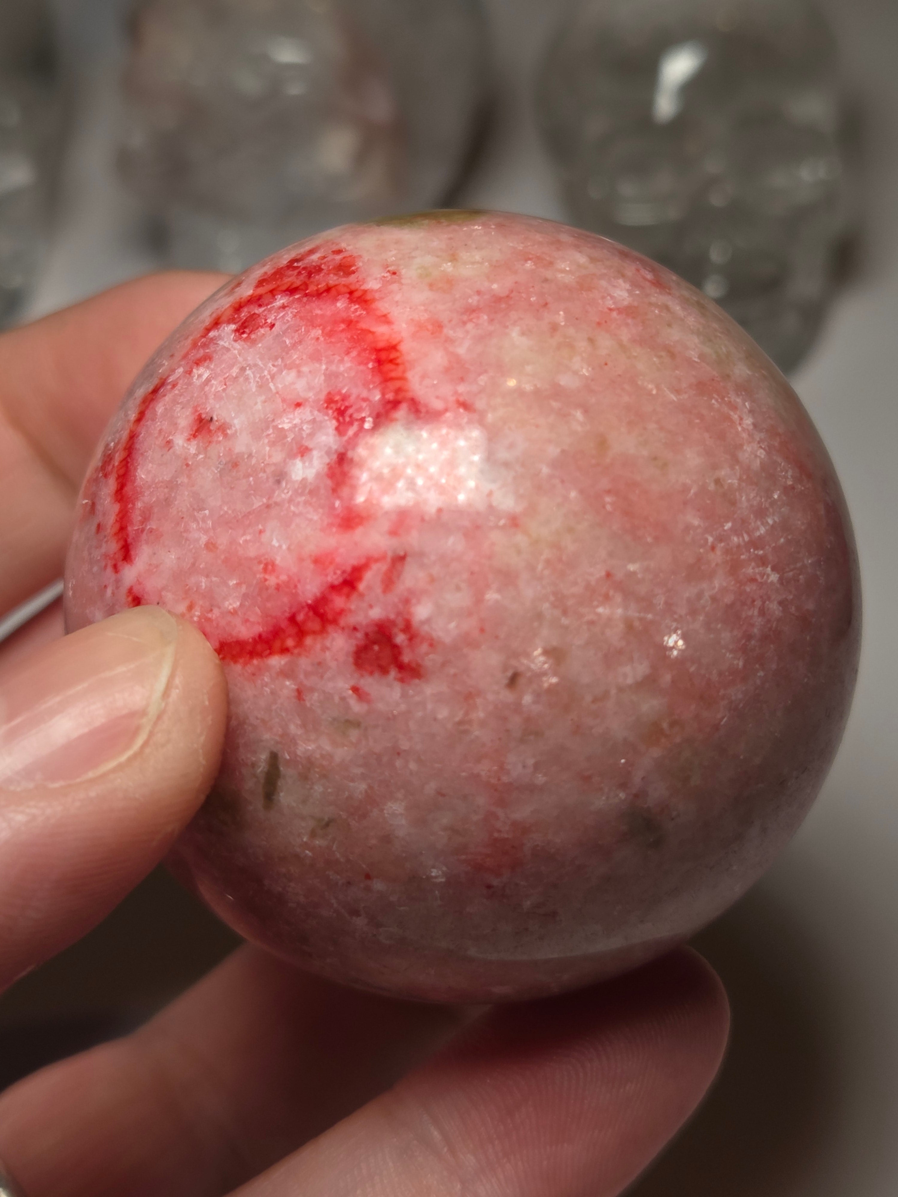 Pink zoisite crystal sphere carving with UV and comes with Stand