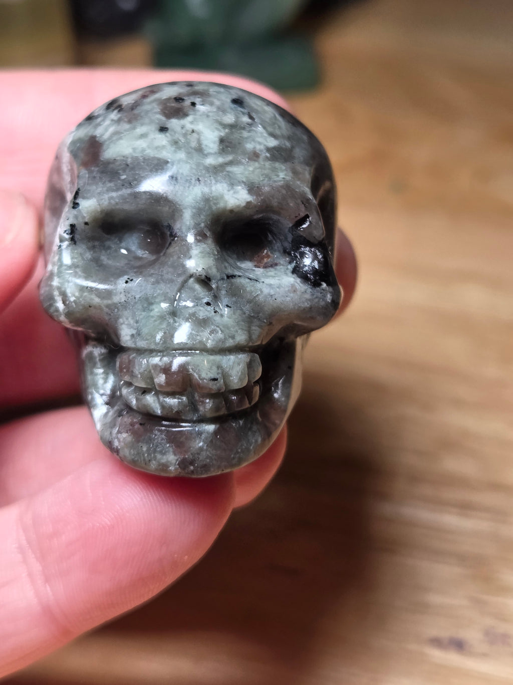 Yooperlite crystal skull carving with orange uv