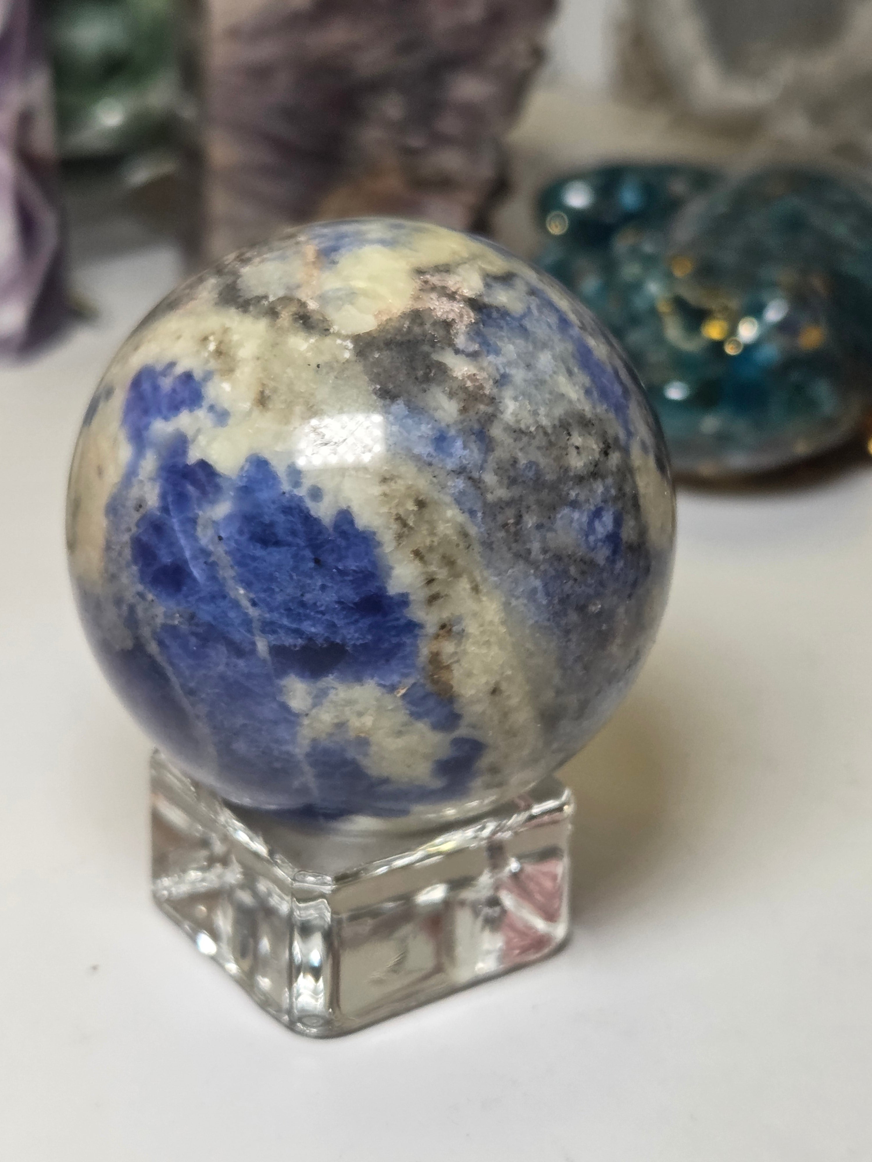 Sodalite crystal sphere carving with stand
