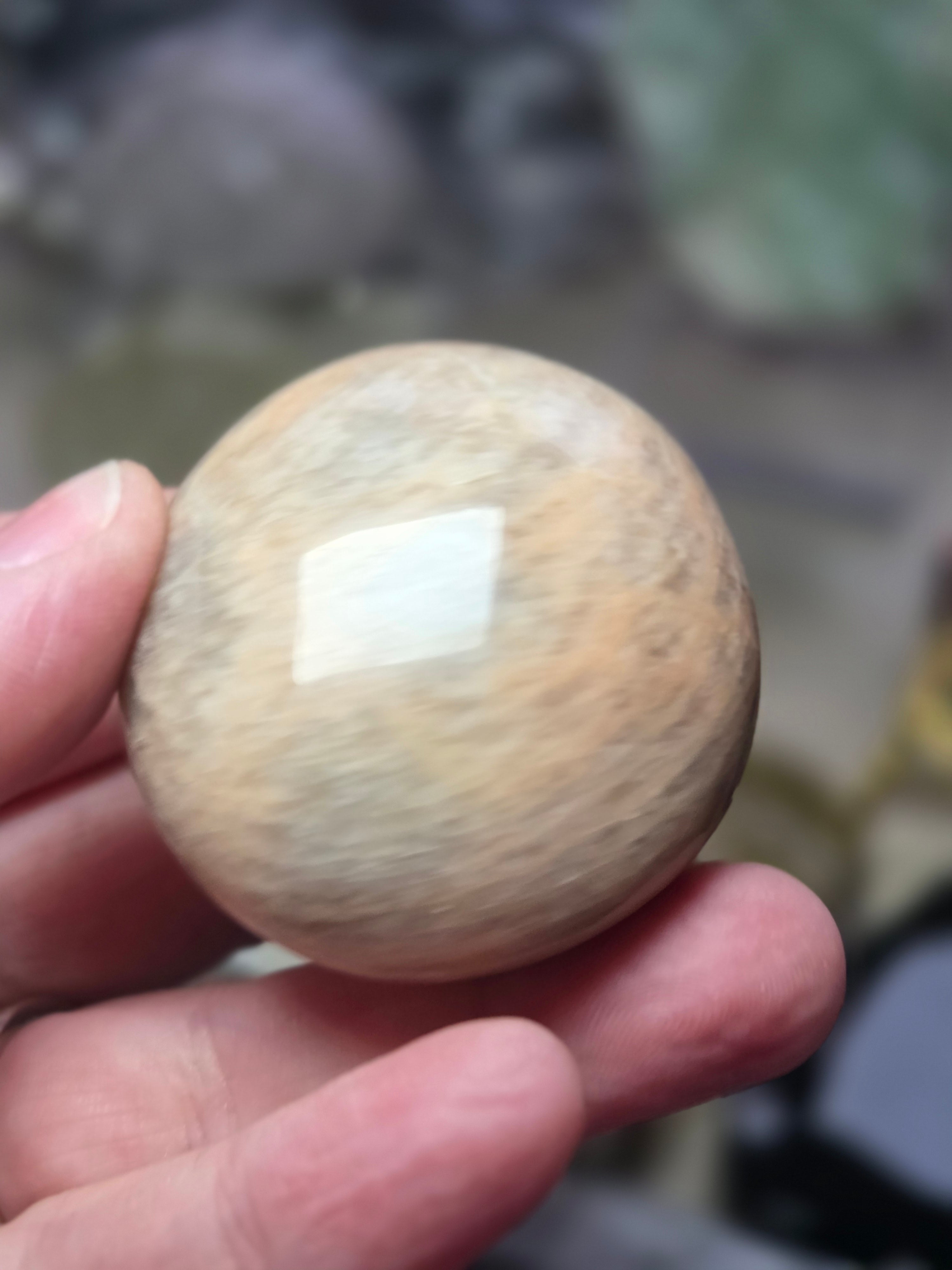 Peach moonstone crystal palm stone with imperfections