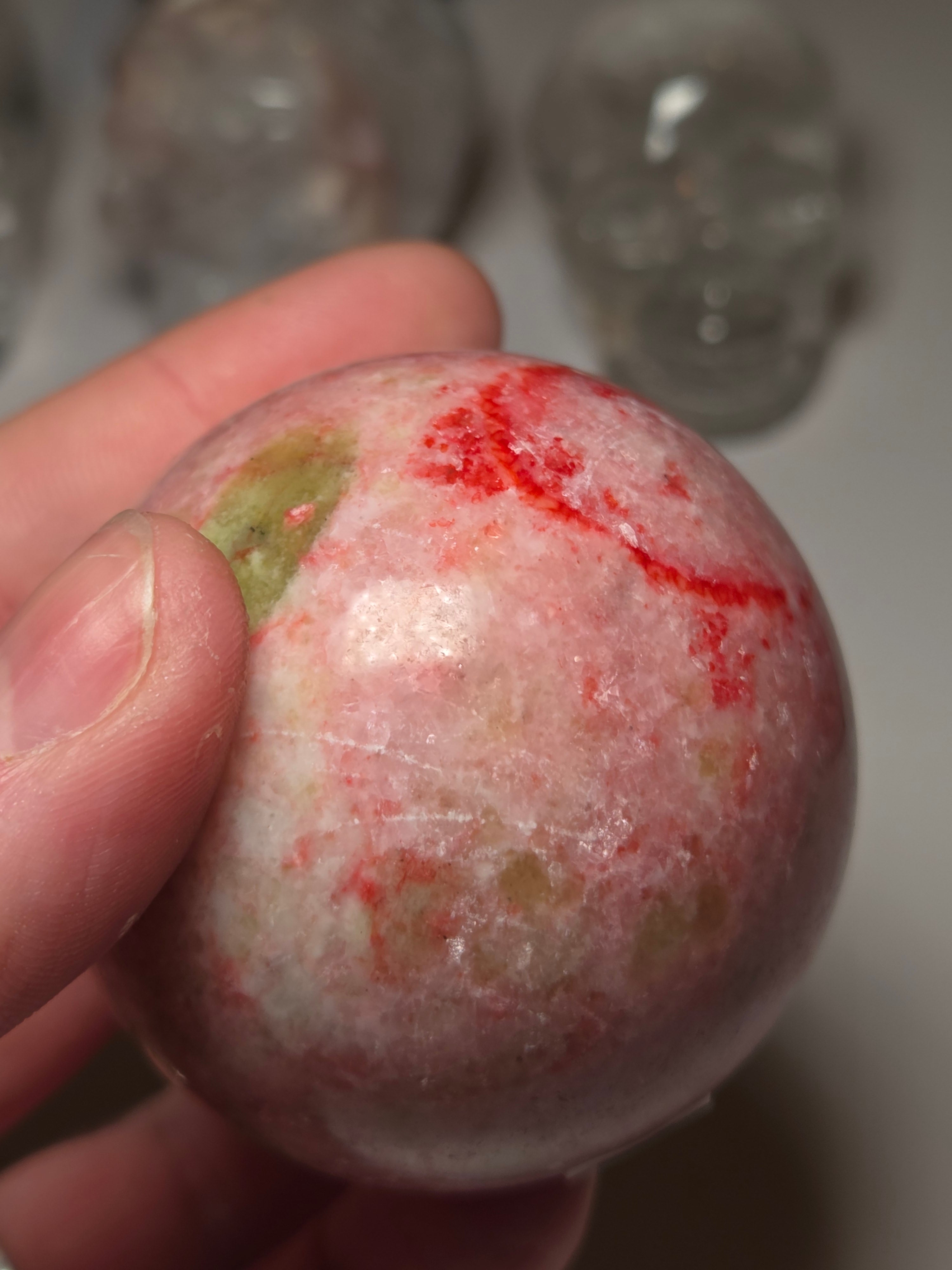 Pink zoisite crystal sphere carving with UV and comes with Stand