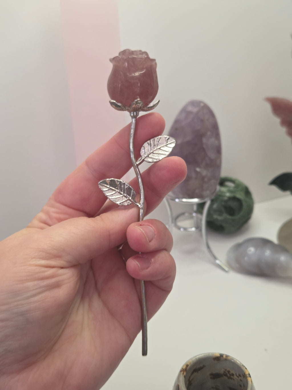 Strawberry quartz crystal rose carving on a stem