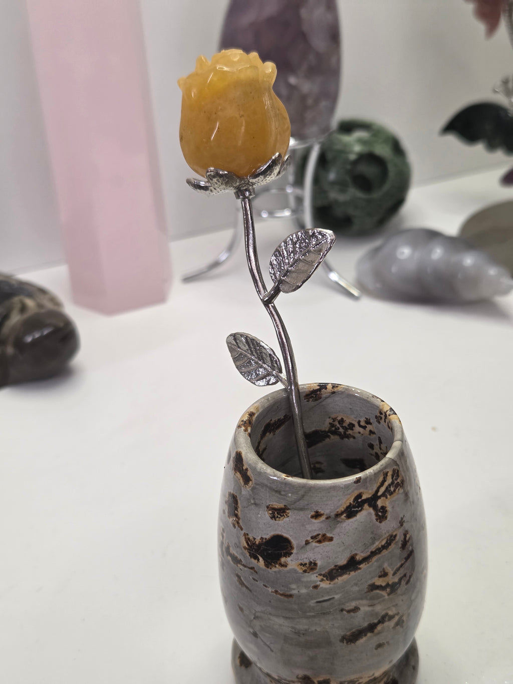 Golden healer crystal rose carving on a stem