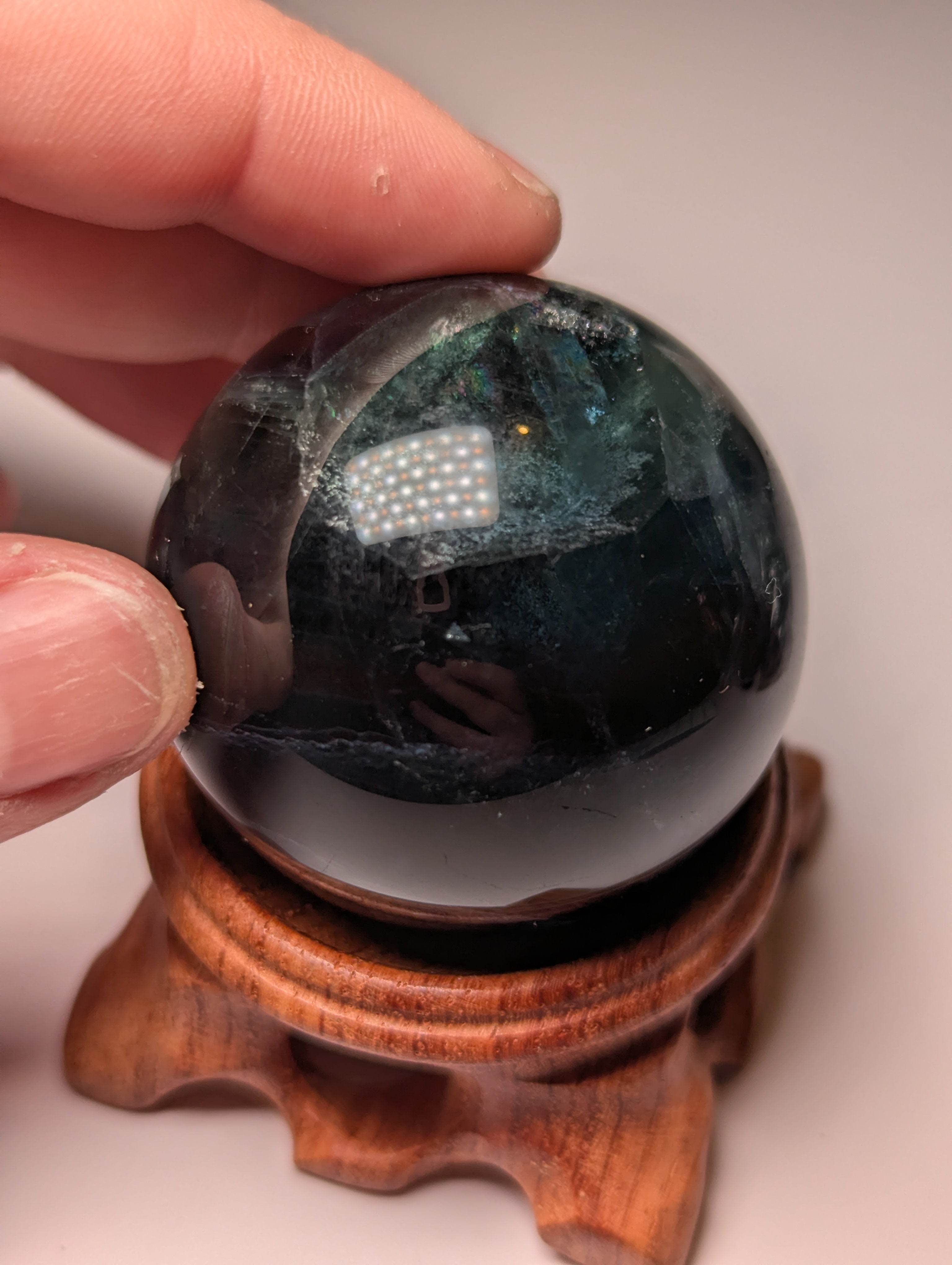 Black flourite crystal sphere with red UV with stand