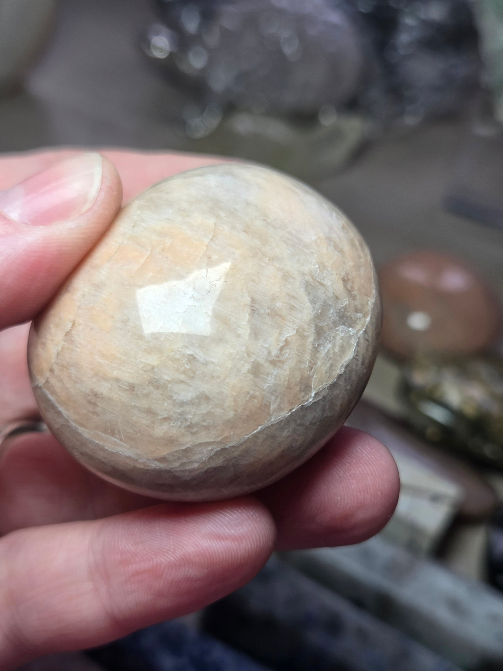 Peach moonstone crystal palm stone with imperfections