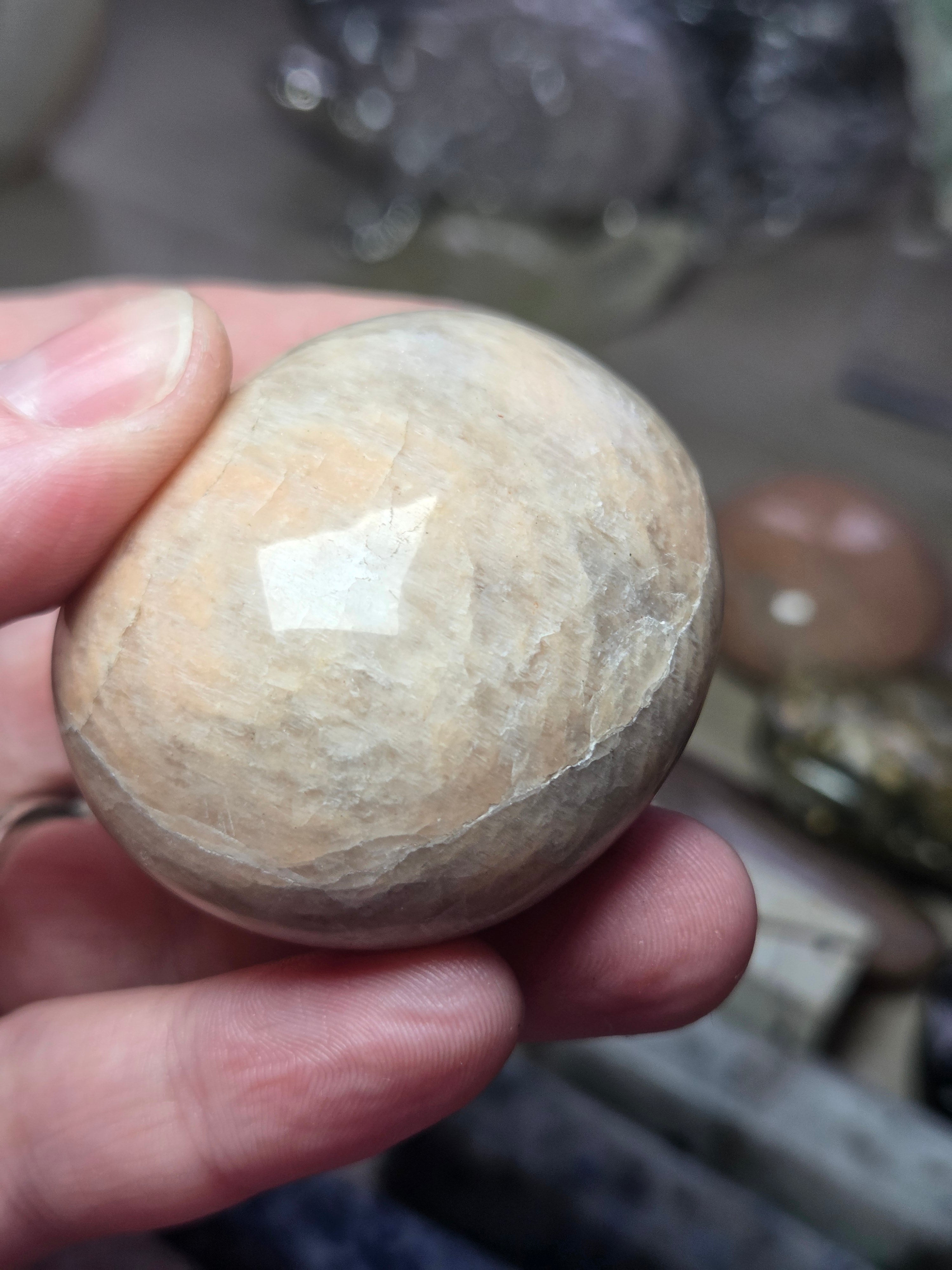 Peach moonstone crystal palm stone with imperfections