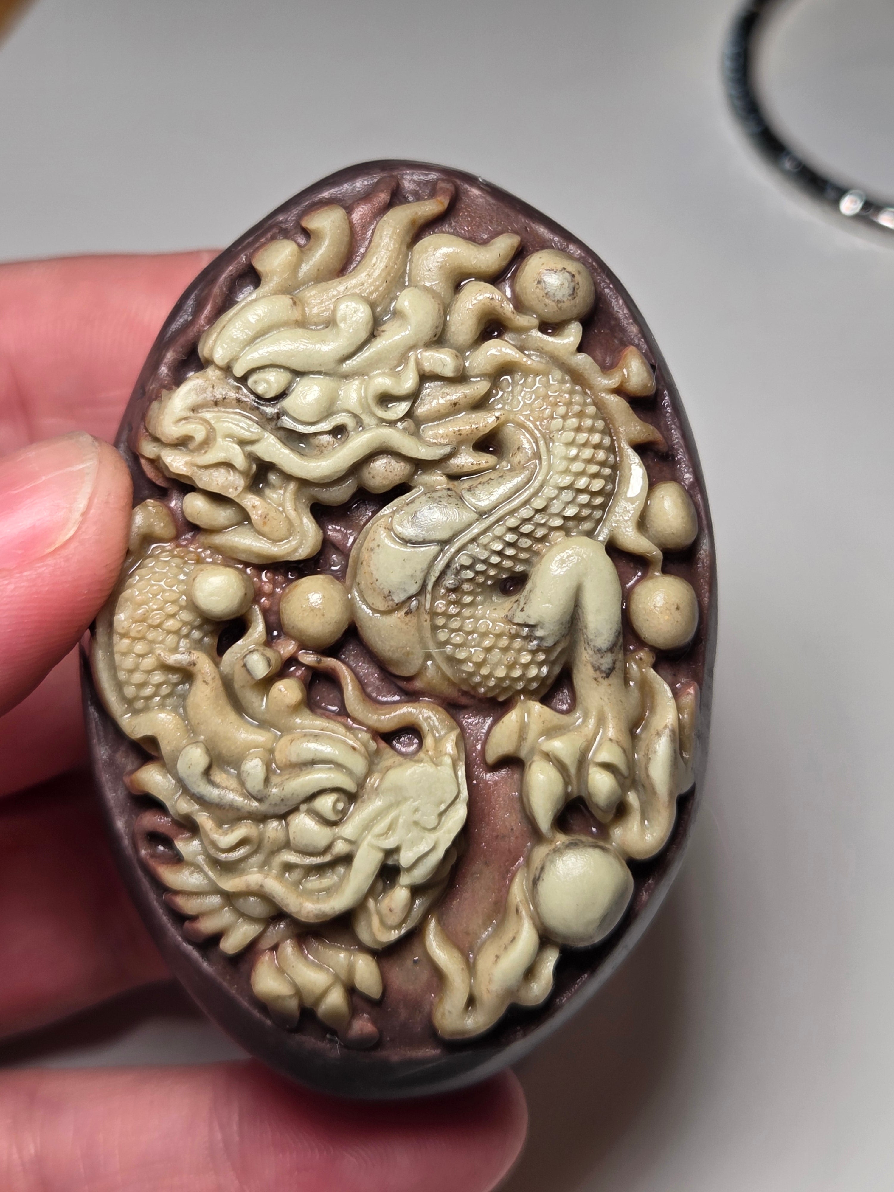Handmade carved dragon palm stone in purple jade from Province