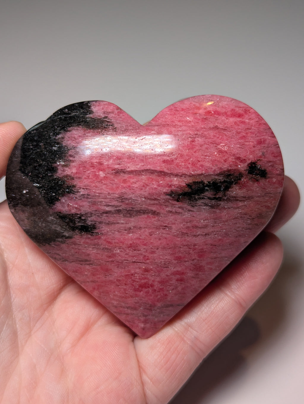 Large Rhodonite crystal heart carving with stand