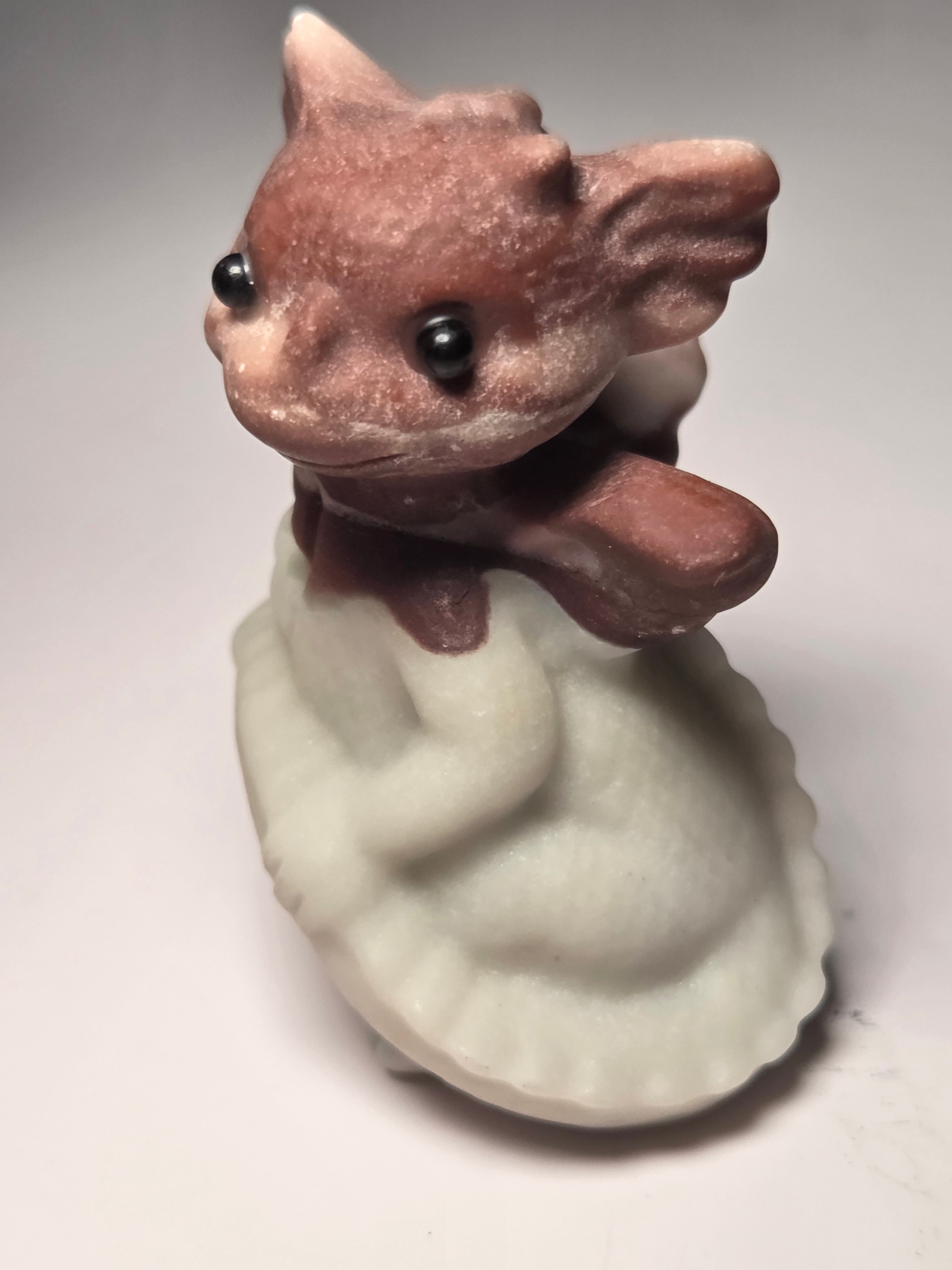 Baby dragon holding tail