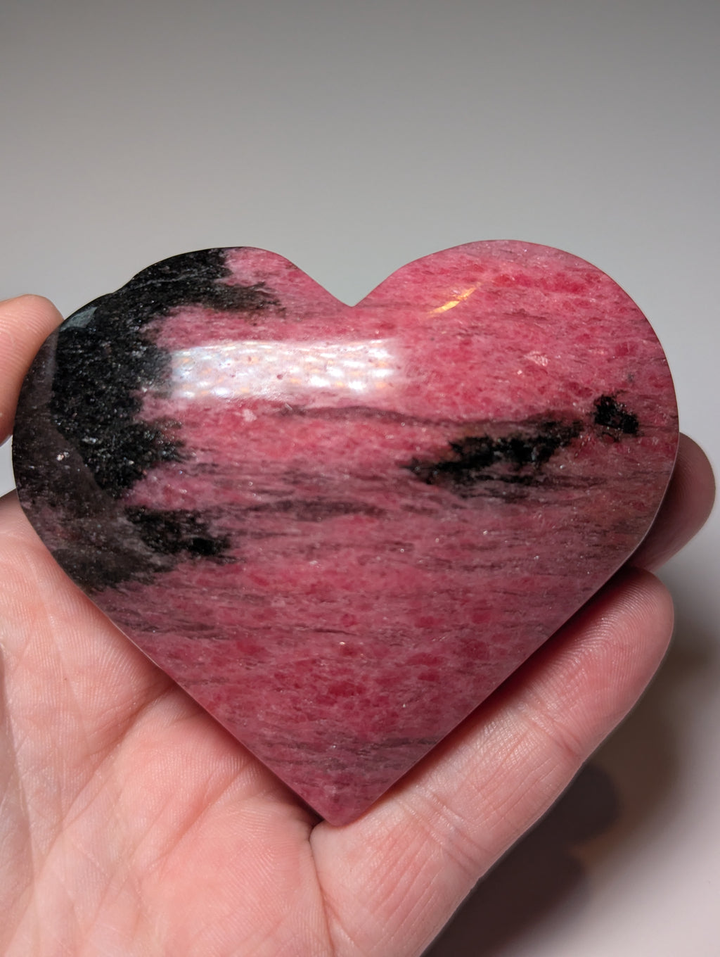 Large Rhodonite crystal heart carving with stand