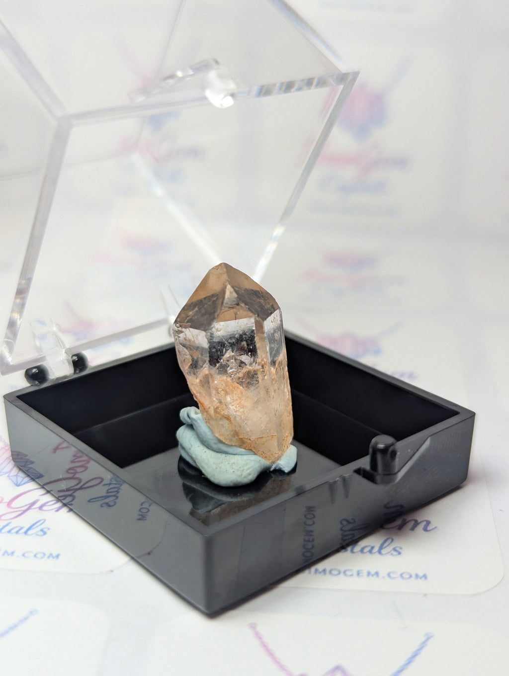 Raw quartz crystal specimen with box
