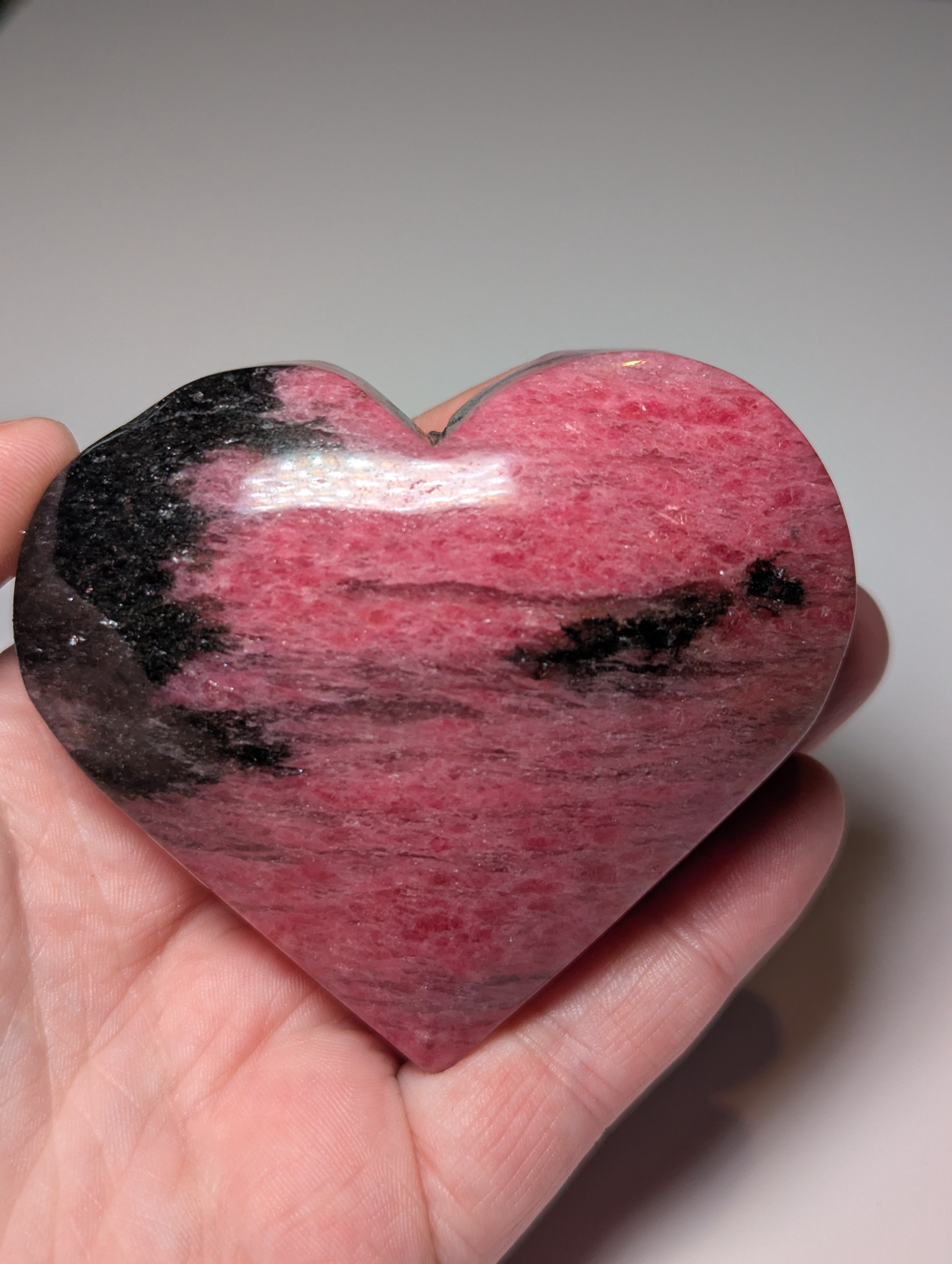 Large Rhodonite crystal heart carving with stand