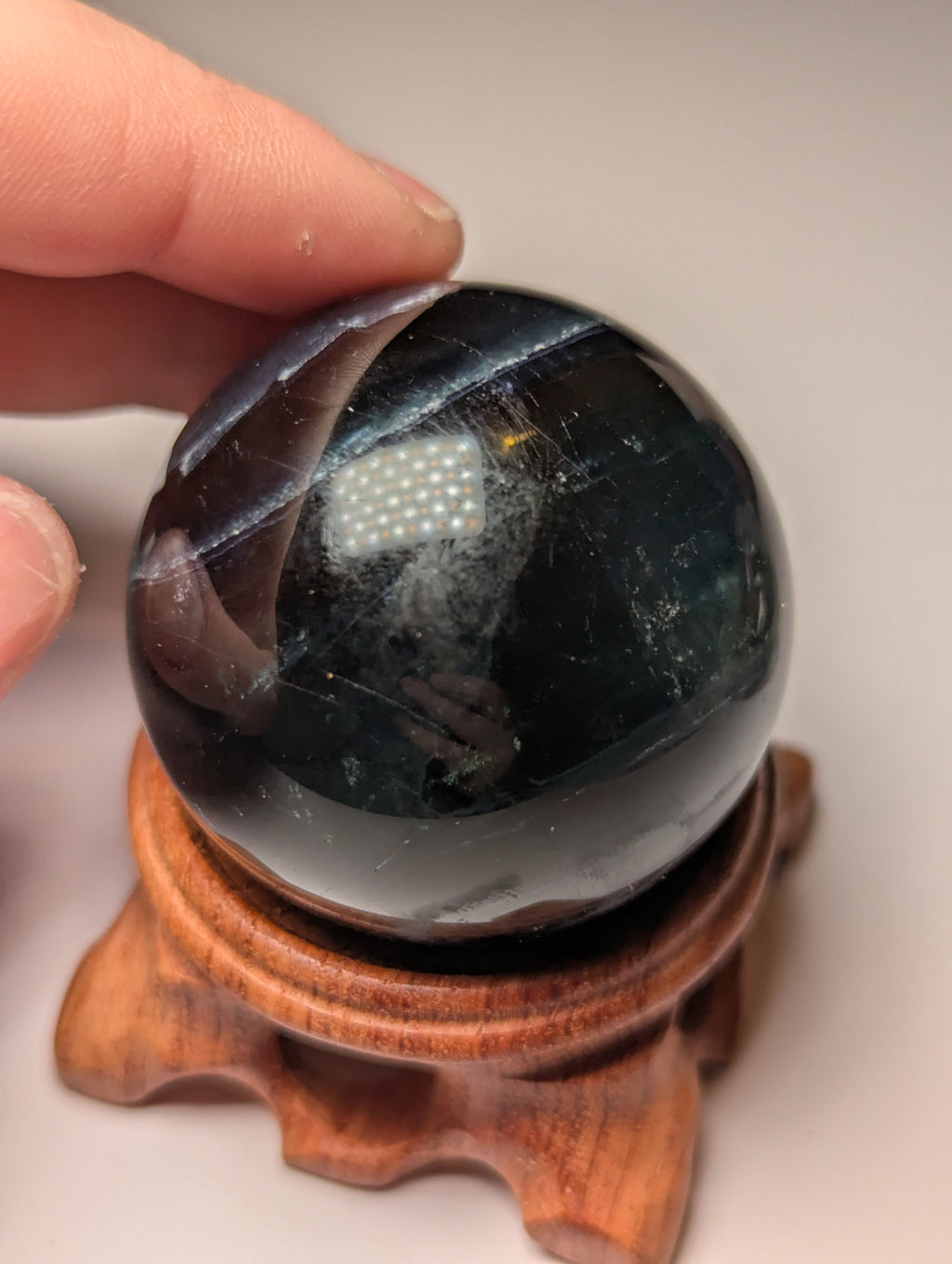 Black flourite crystal sphere with red UV with stand