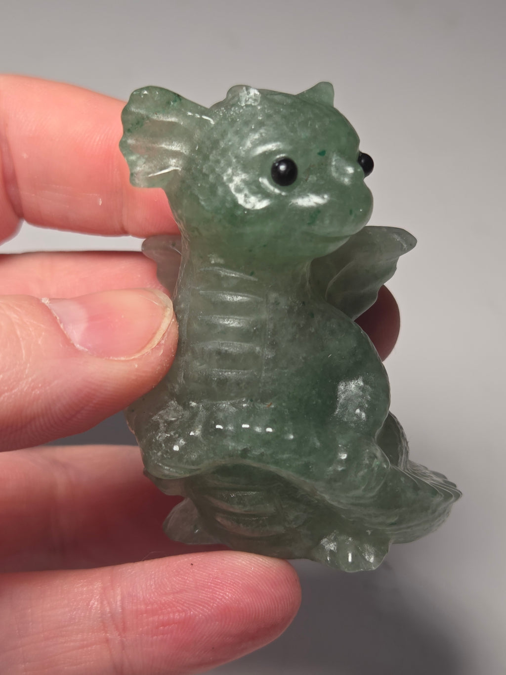 Baby dragon holding tail