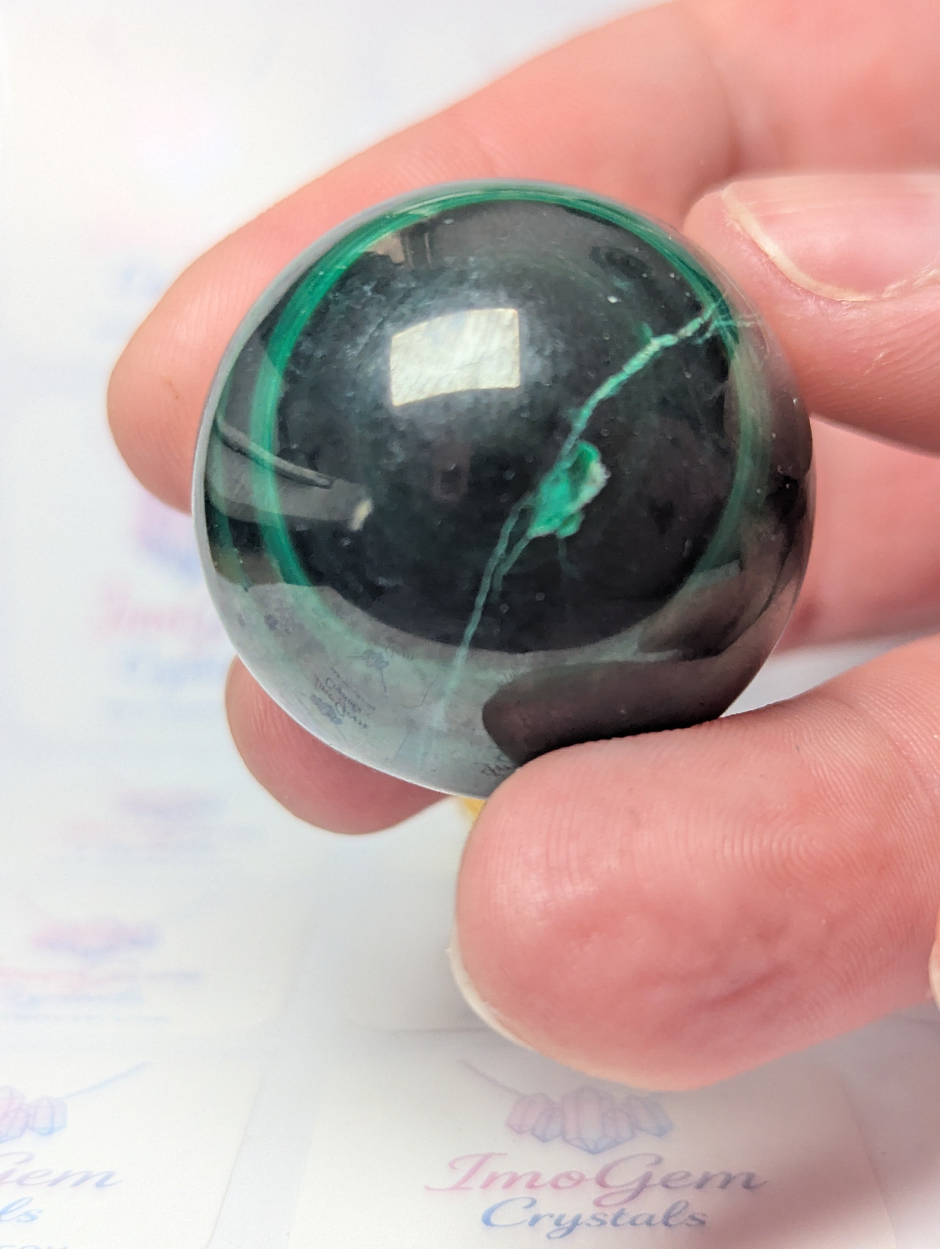 Malicite crystal sphere with imperfections