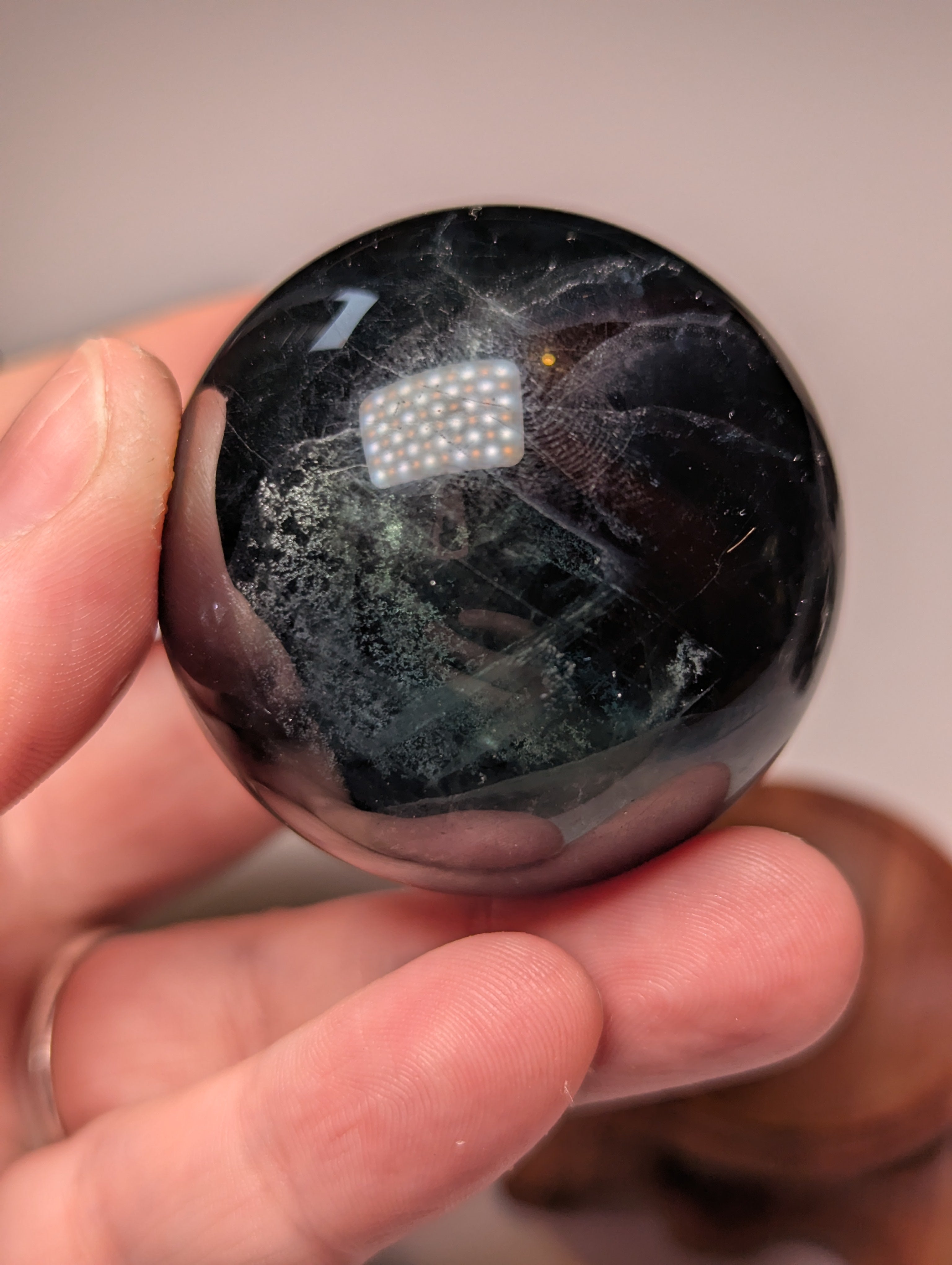Black flourite crystal sphere with red UV with stand