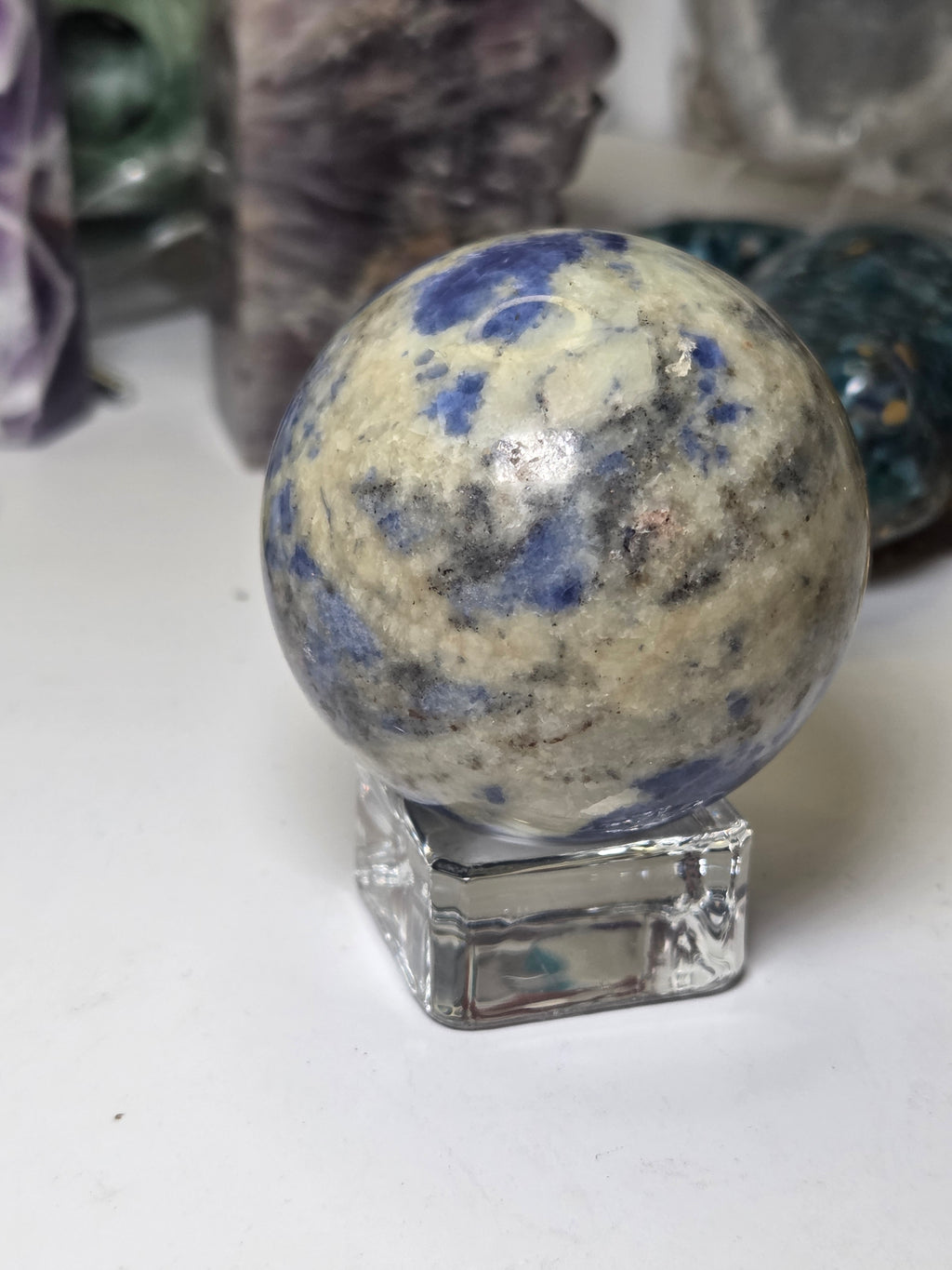 Sodalite crystal sphere carving with stand