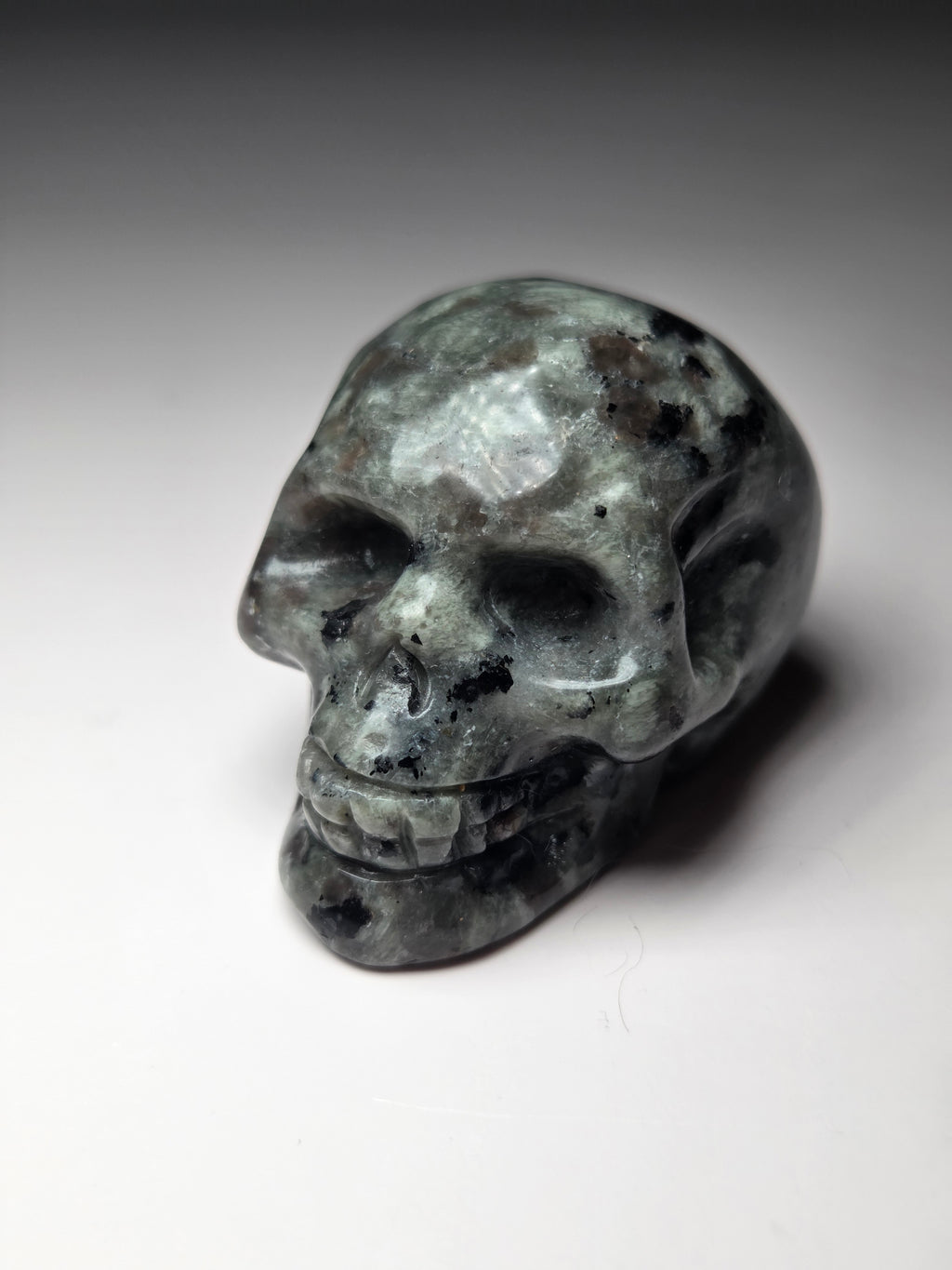 Yooperlite crystal skull carving with orange uv