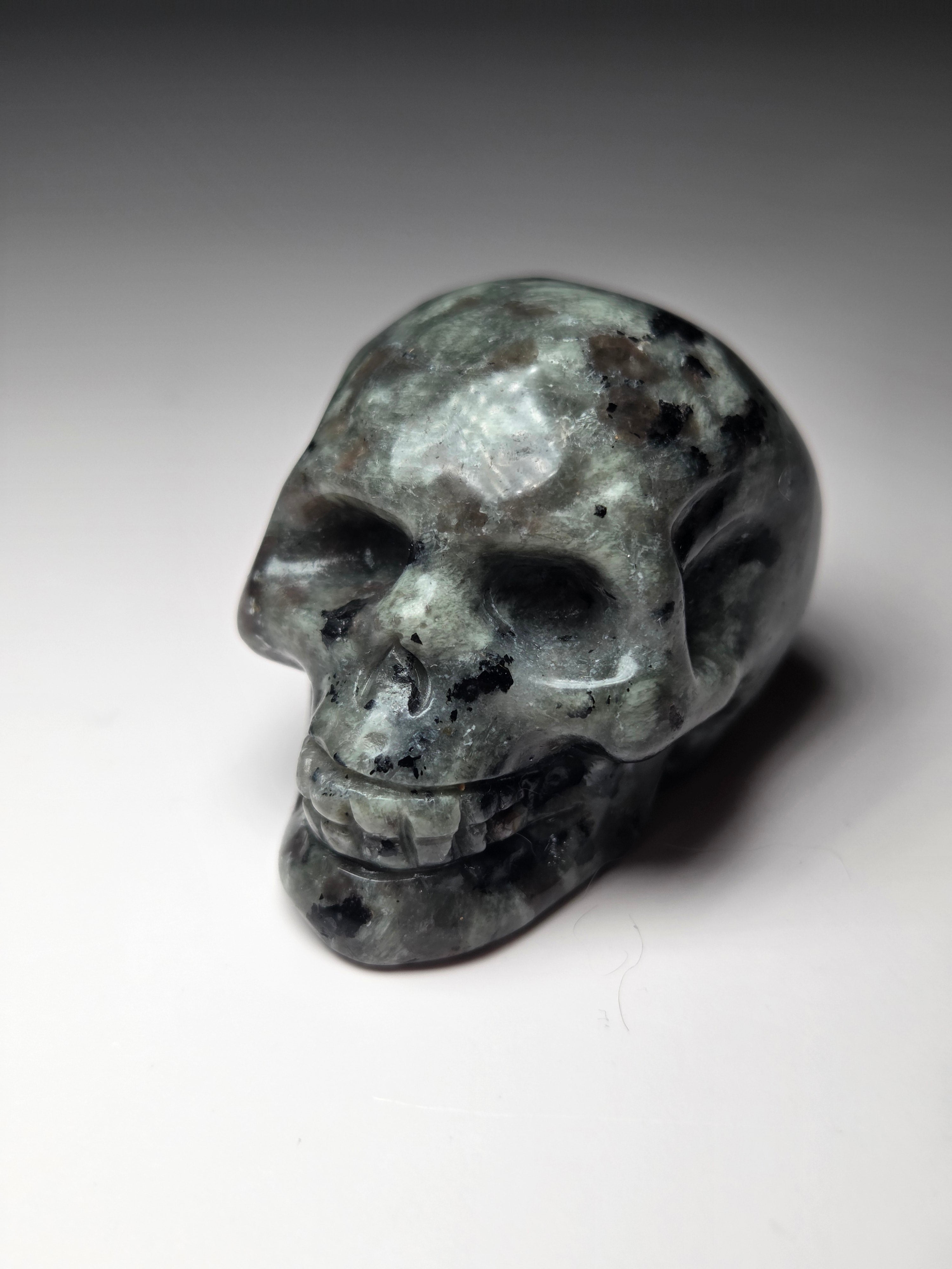 Yooperlite crystal skull carving with orange uv