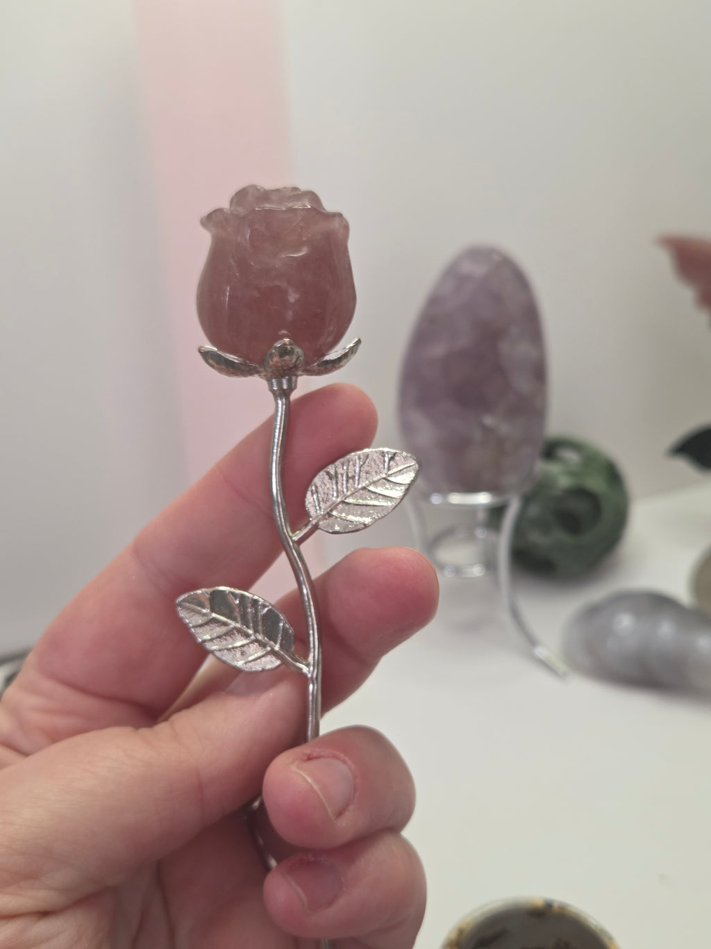 Strawberry quartz crystal rose carving on a stem