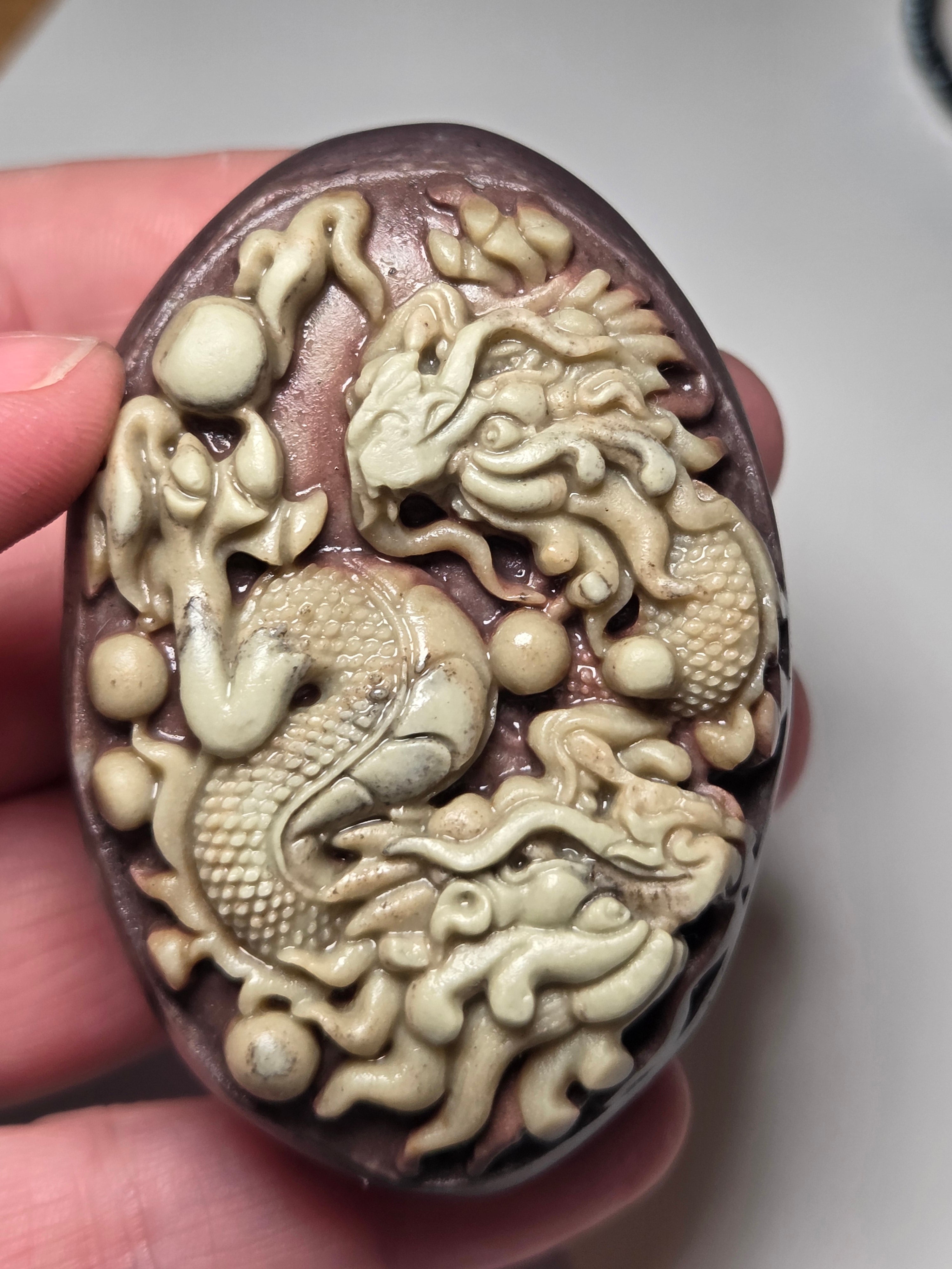 Handmade carved dragon palm stone in purple jade from Province