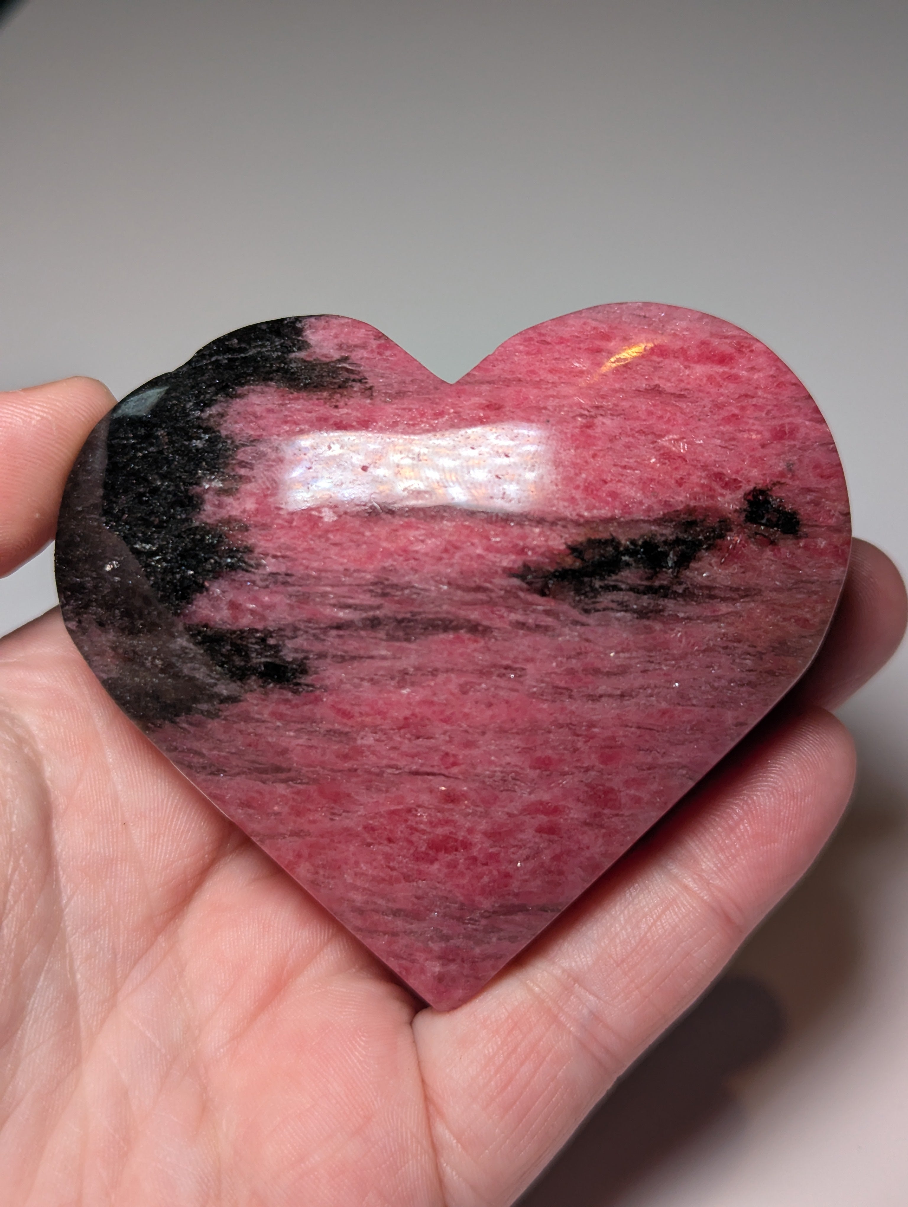 Large Rhodonite crystal heart carving with stand