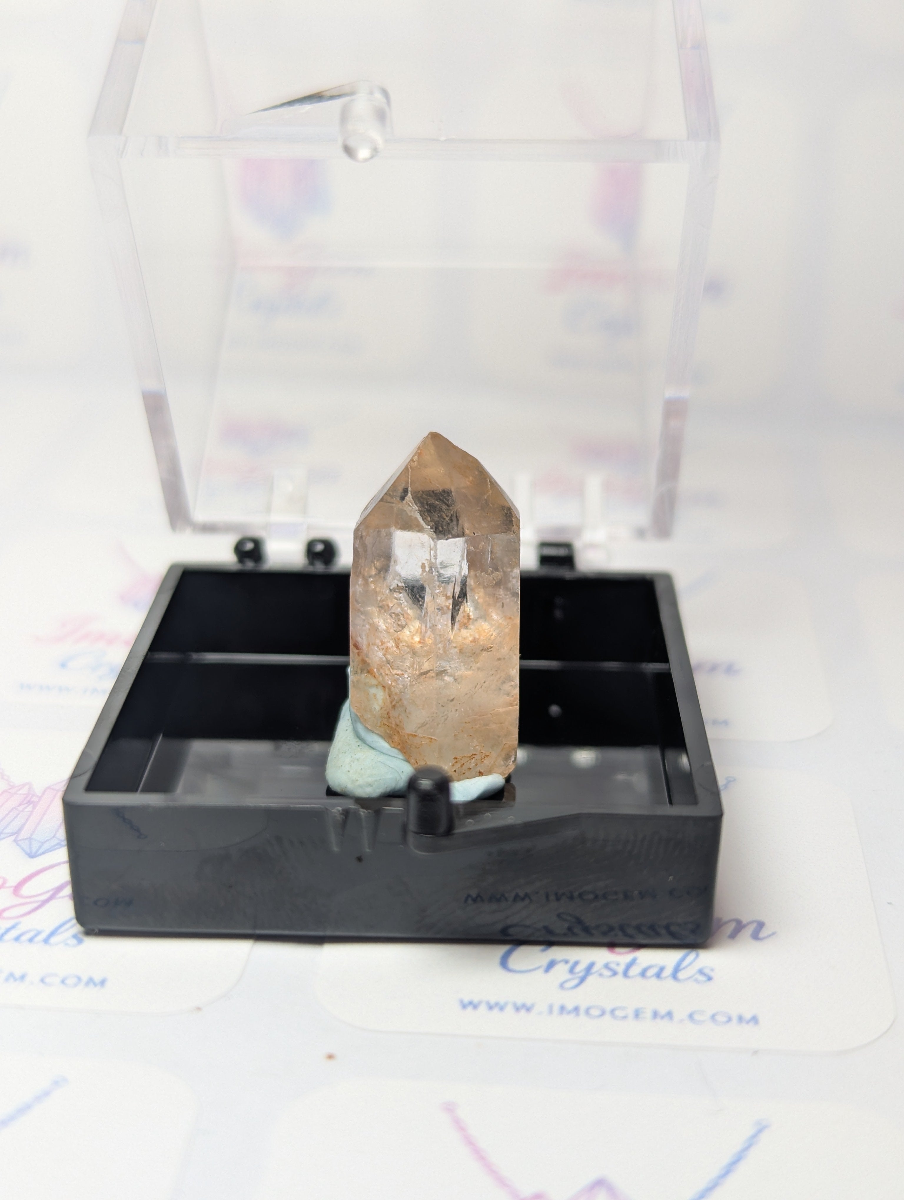 Raw quartz crystal specimen with box
