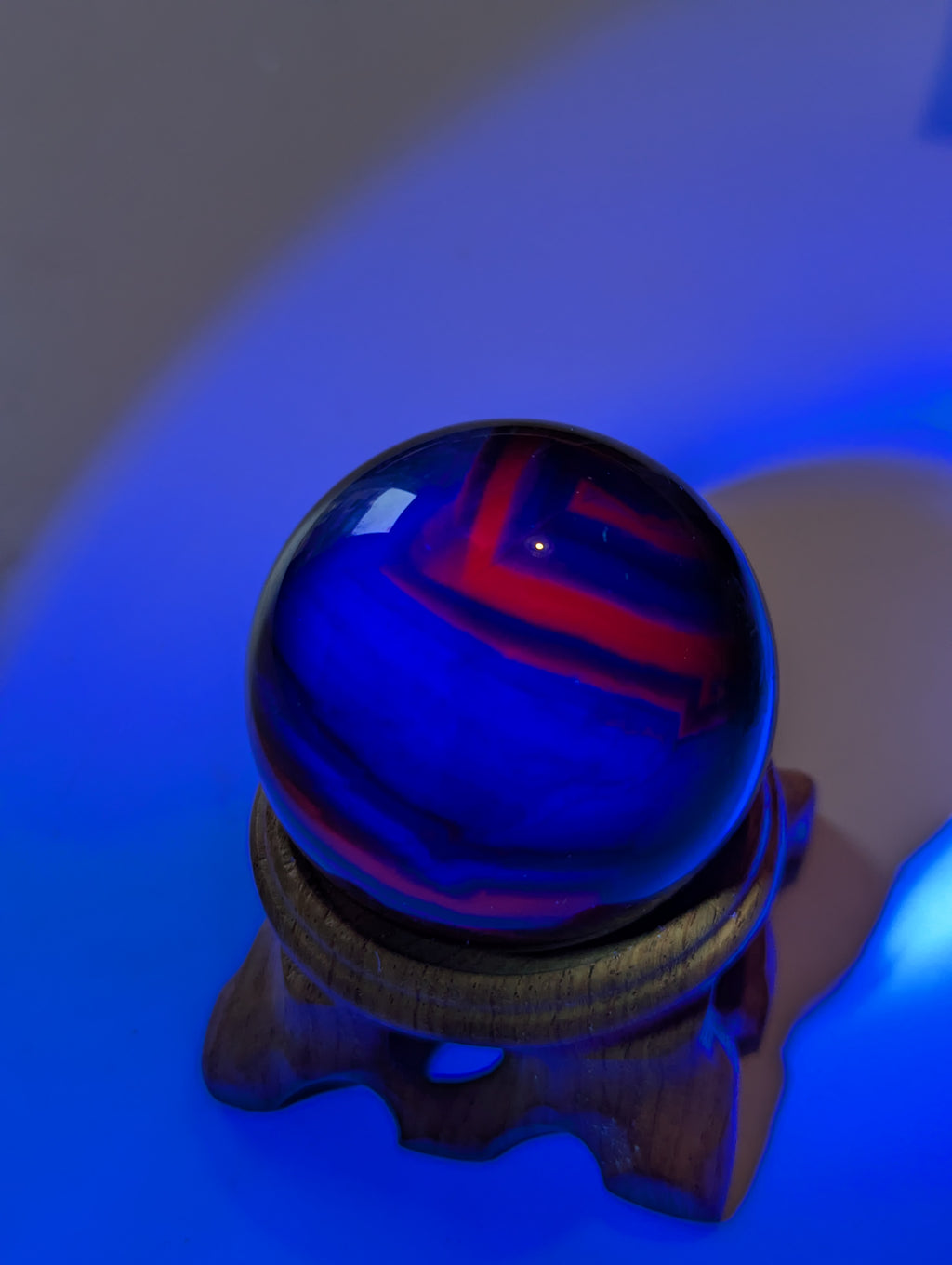 Black flourite crystal sphere with red UV with stand