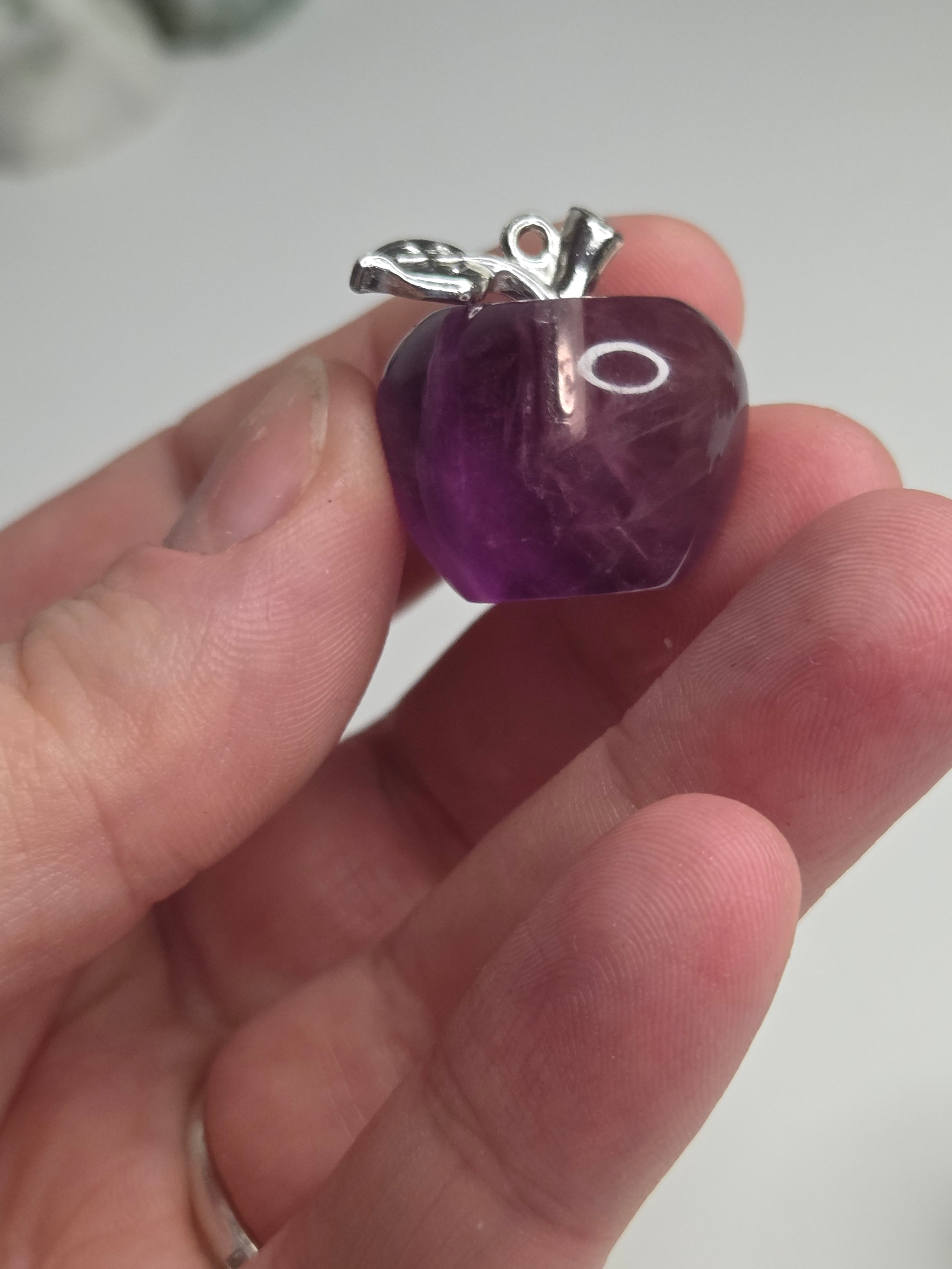 Purple flourite crystal apple carving could be made into a pendant