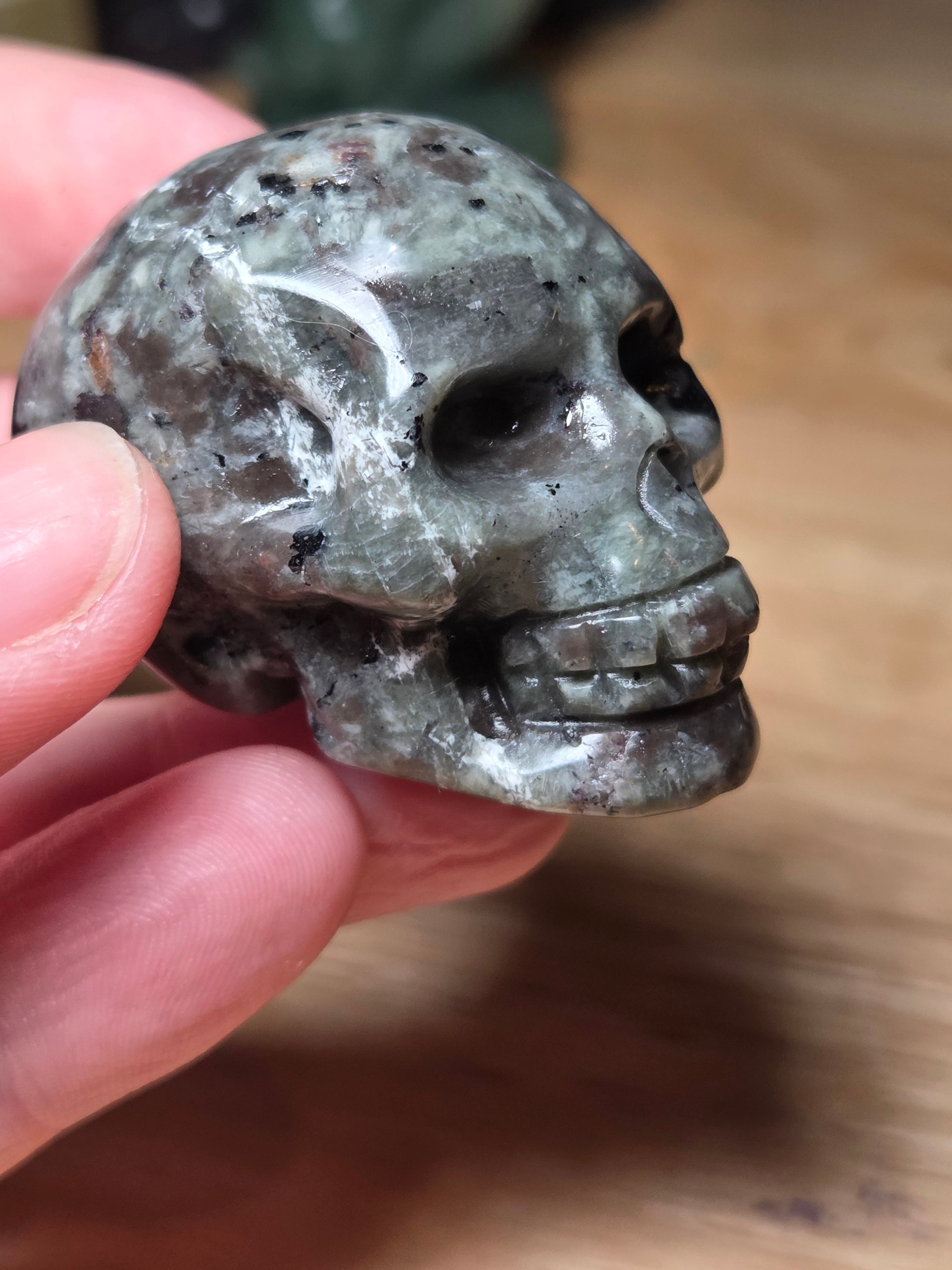 Yooperlite crystal skull carving with orange uv