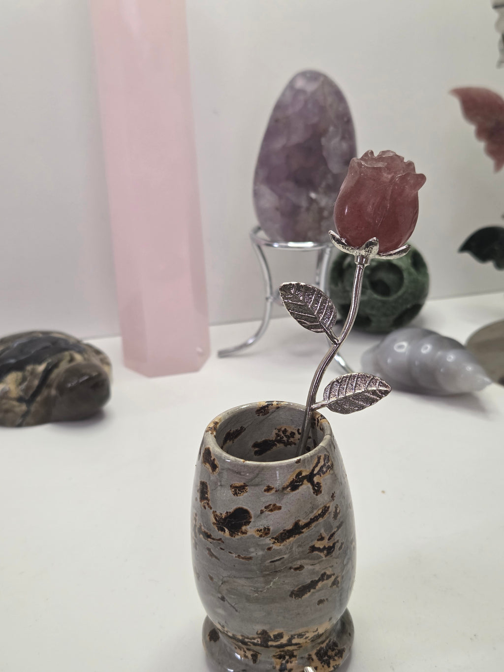 Strawberry quartz crystal rose carving on a stem