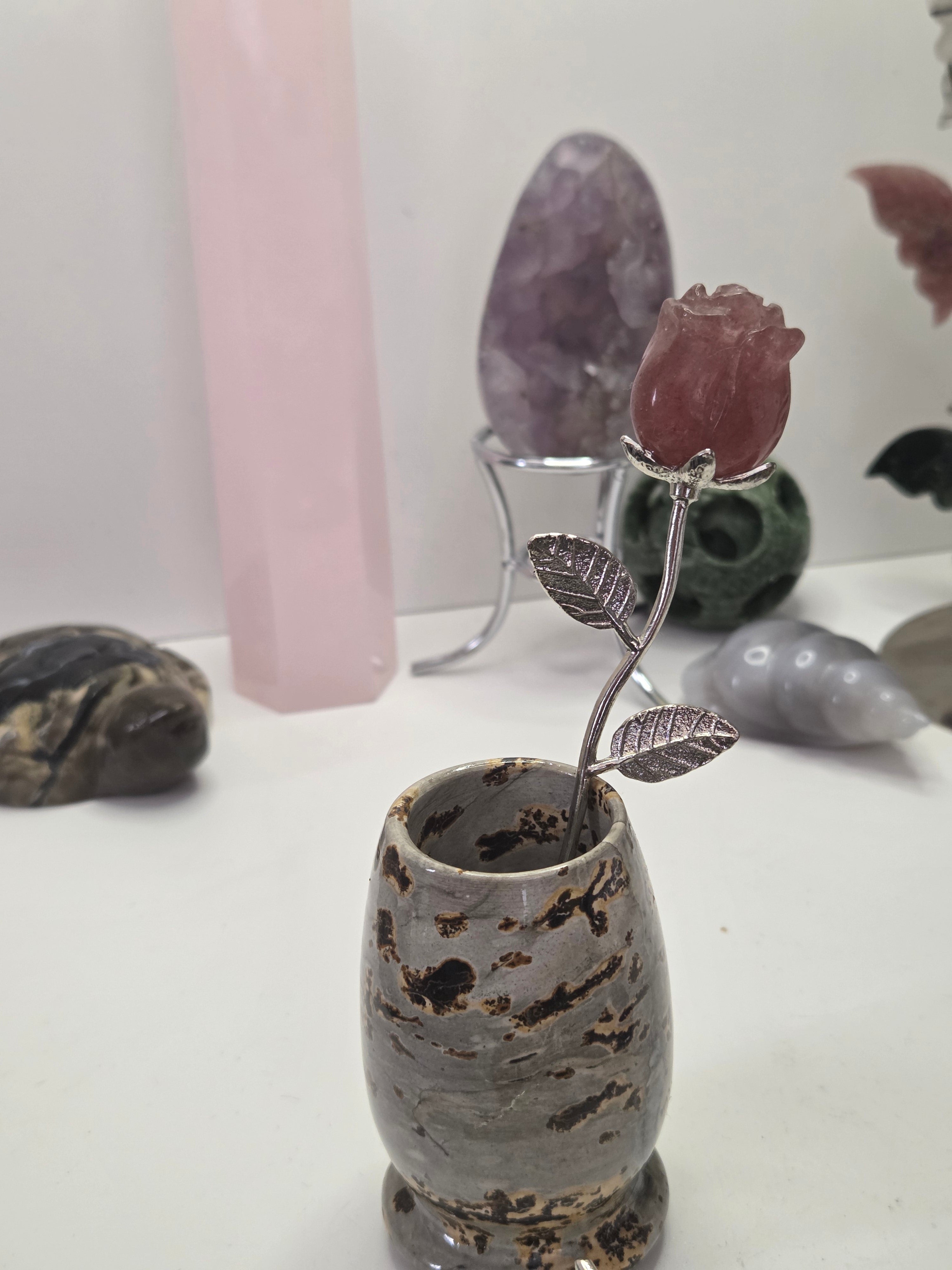 Strawberry quartz crystal rose carving on a stem